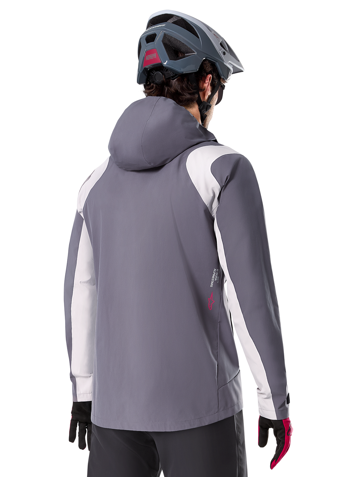 Alpinestars A-Dura Rain Jacket, Mountain Bike Jacket, Dark Titanium Gray, back view featuring light gray shoulder and arm panels, red logo detail on the side, worn with a gray MTB helmet and black and red gloves, technical trail riding apparel