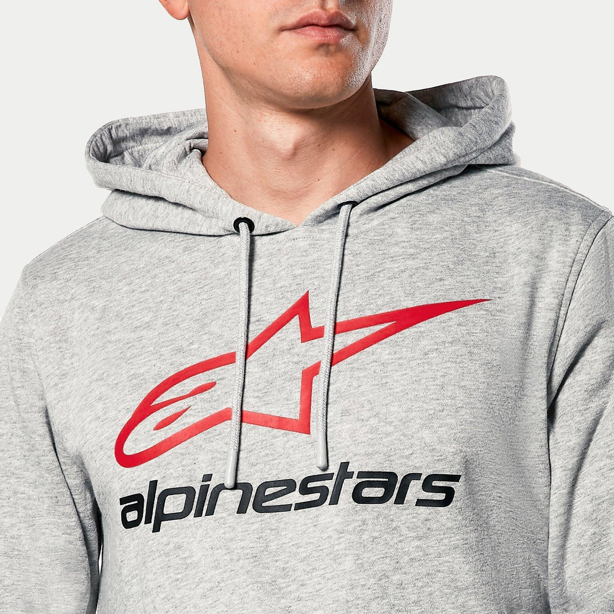 Alpinestars Always V3 Hoodie, Grey Heather, close-up of chest featuring red star logo and black Alpinestars text, jersey-lined hood with grey drawcords, casual motorsport streetwear