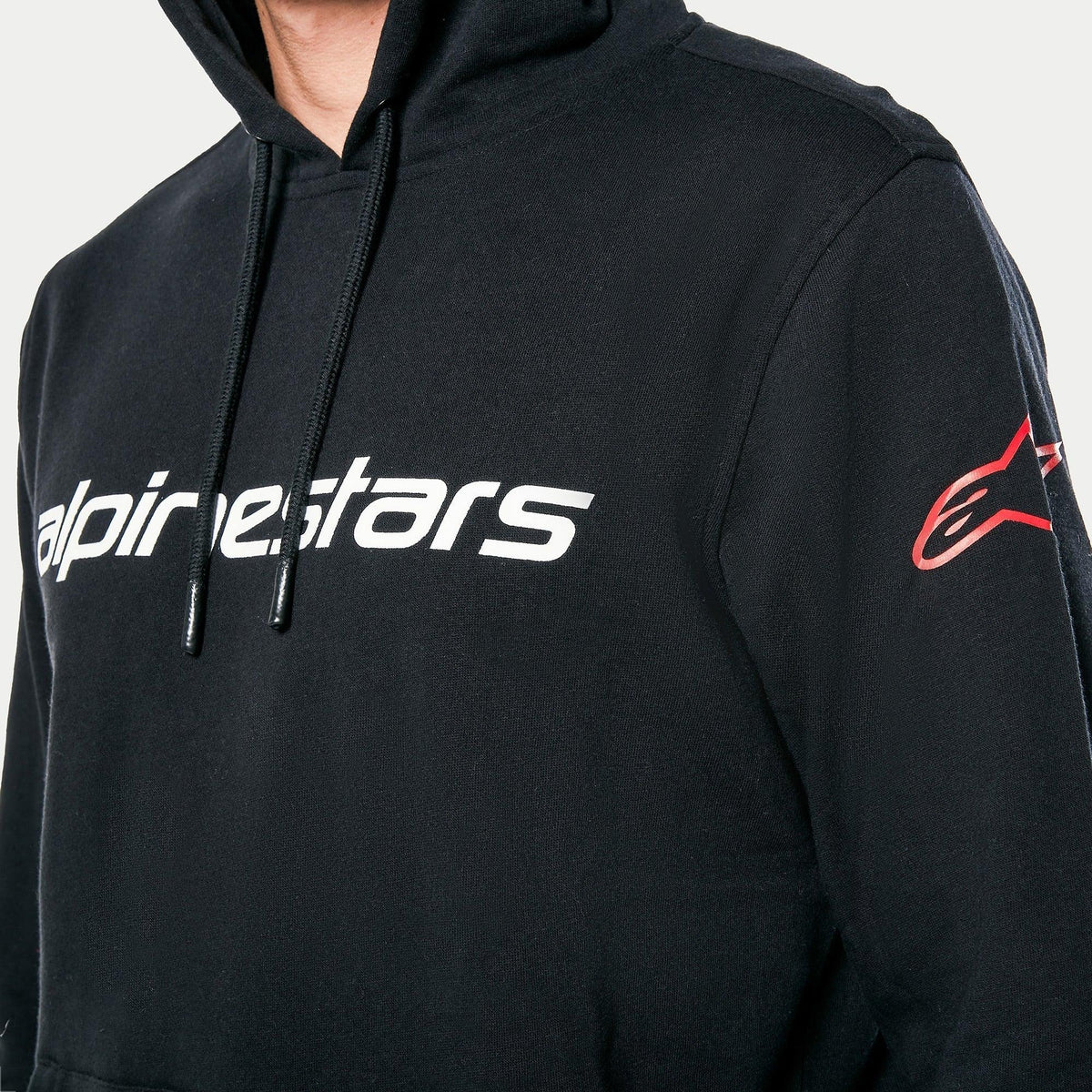 Alpinestars Linear Wordmark V3 hættetrøje, sort, hvidt Alpinestars-navnetræk på brystet og rødt Ageless-logo på ærmet, afslappet sportswear pullover-fleece med hætte med snoretræk