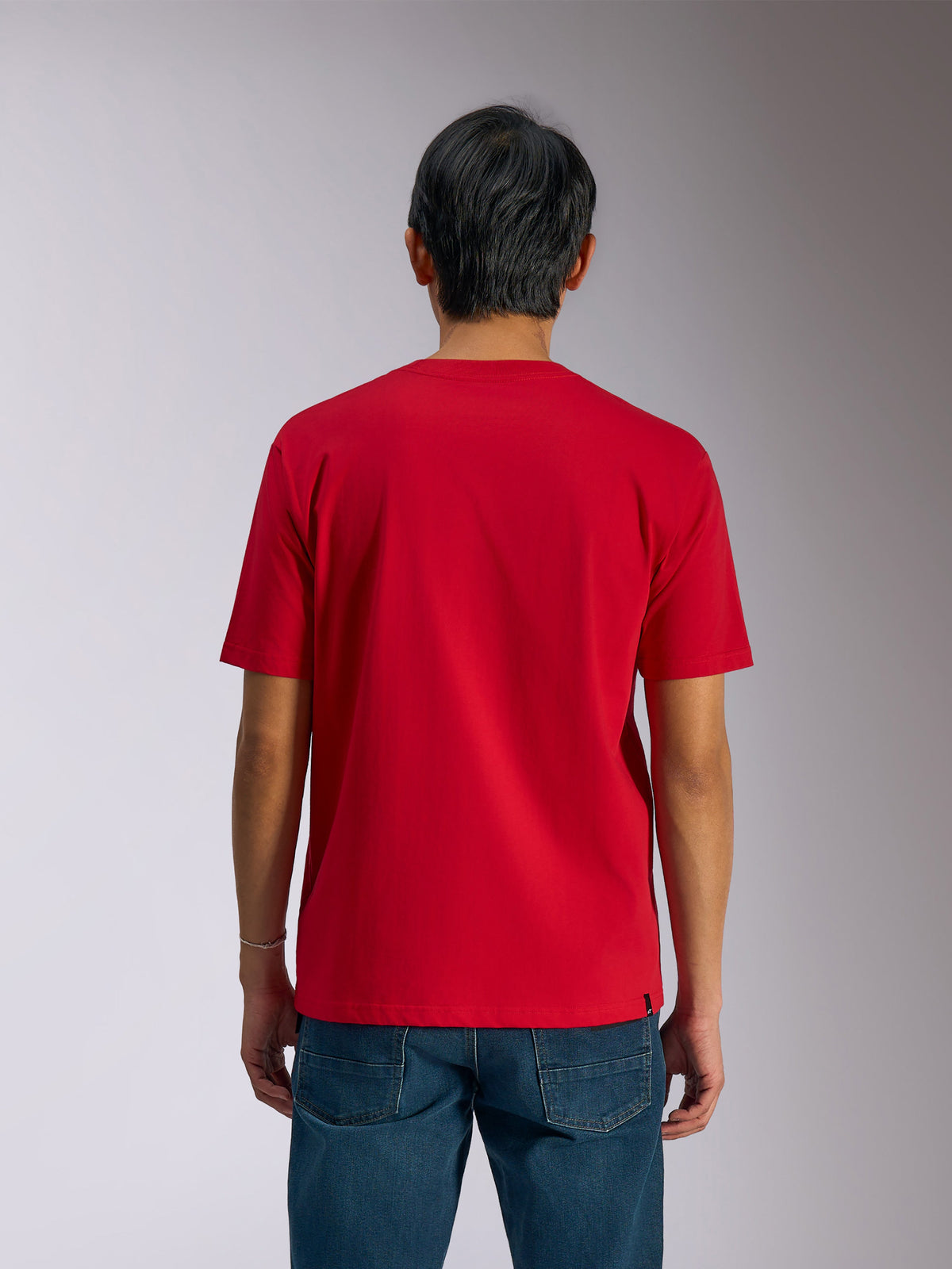 Alpinestars Ageless Shadow CSF Tee, set bagfra, kortærmet t-shirt, rød, afslappet motorsport streetwear, båret med blå jeans