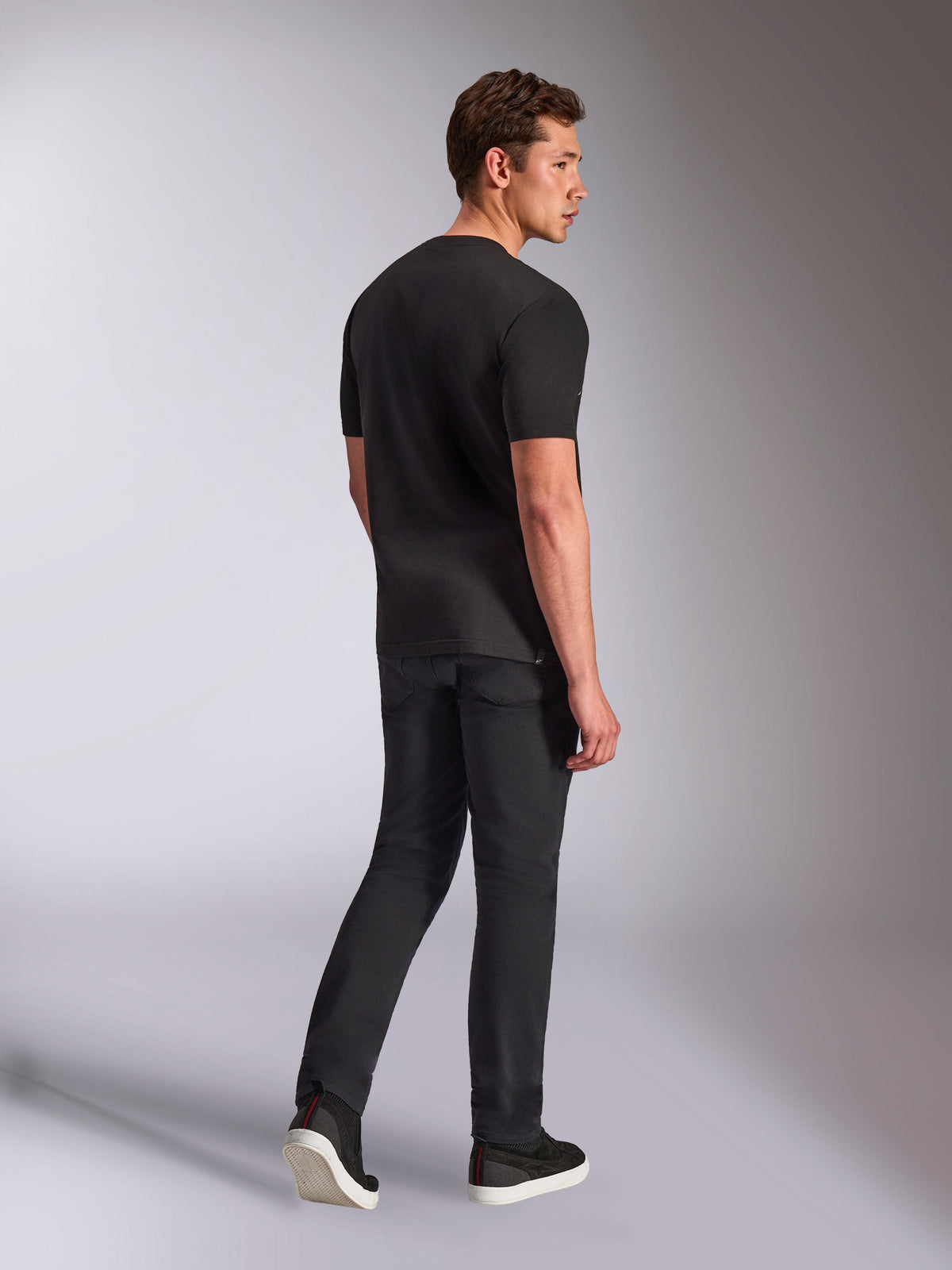 Alpinestars Trifecta CSF Tee, Short Sleeve T-Shirt, Black, rear view of a man wearing the shirt with black jeans and sneakers, casual motorsport streetwear