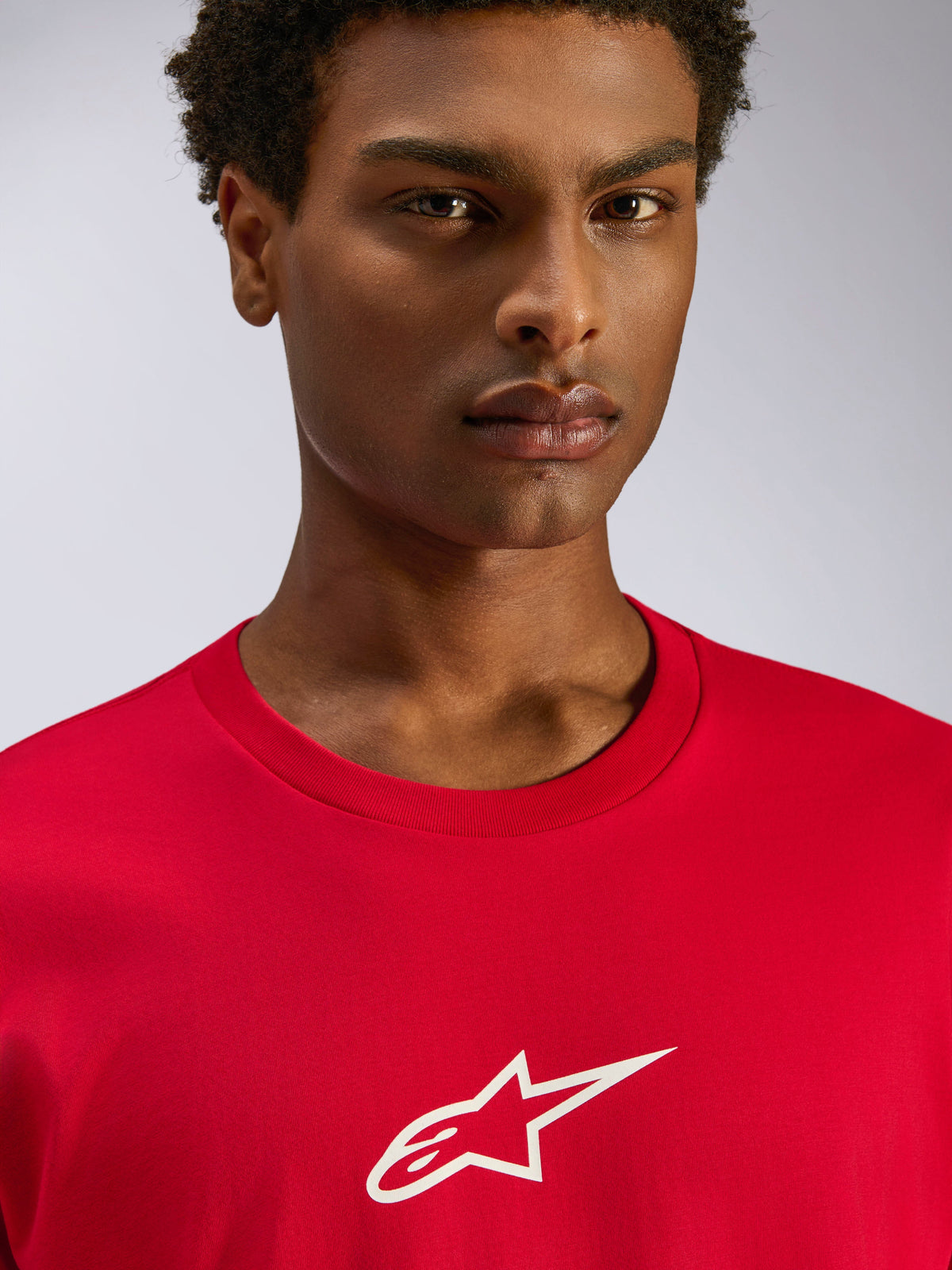 Alpinestars Frontal CSF Tee, Short Sleeve T-Shirt, Red, White Astars Logo on Chest, Close-up of model wearing sustainable performance wicking sportswear