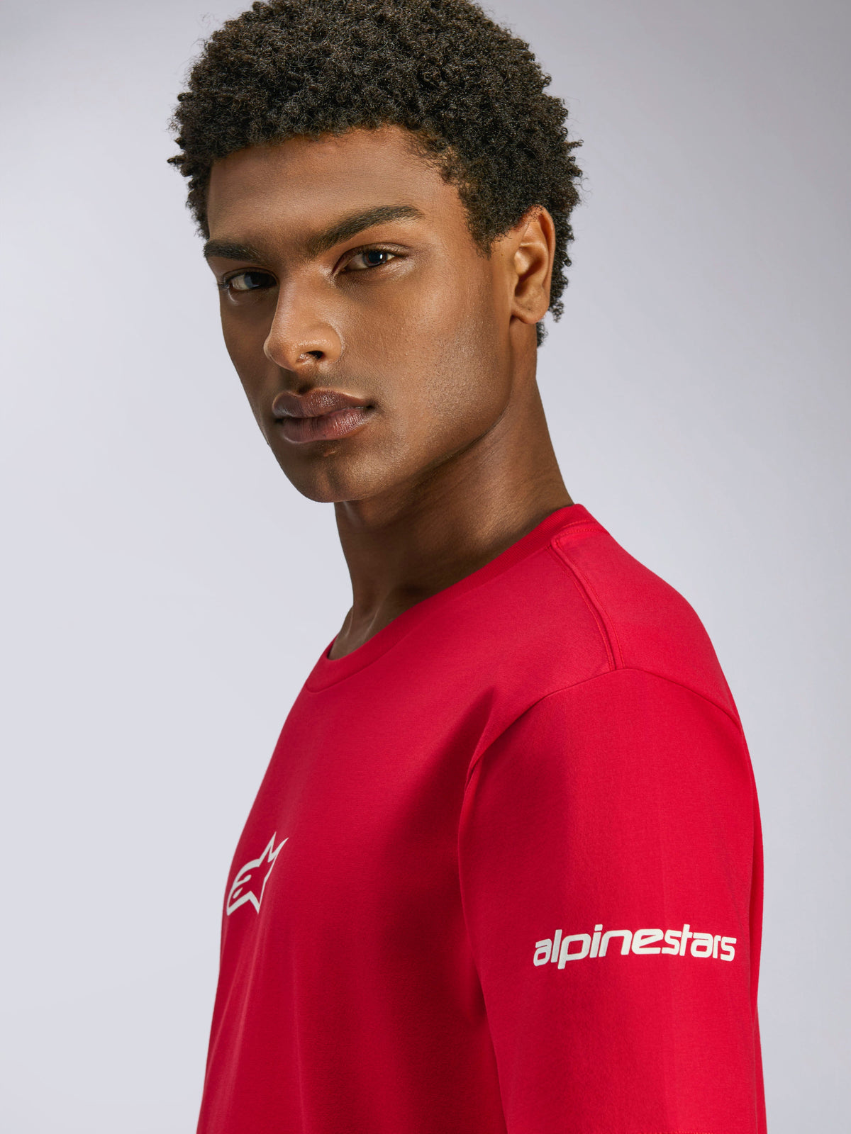 Alpinestars Frontal CSF Tee, Red Short Sleeve T-Shirt, featuring white logos on the chest and sleeve, worn by a model, casual performance motorsport streetwear