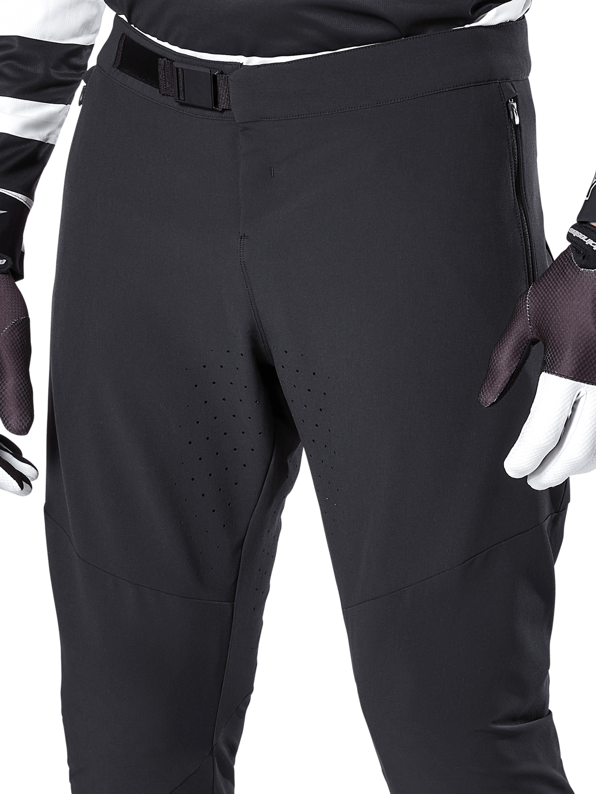 Alpinestars A-Aria Elite bukser, sorte mountainbike-bukser, nærbillede af fronttaljen og lårene med magnetisk spændelukning og laserskårne ventilationshuller, kombineret med cykelhandsker