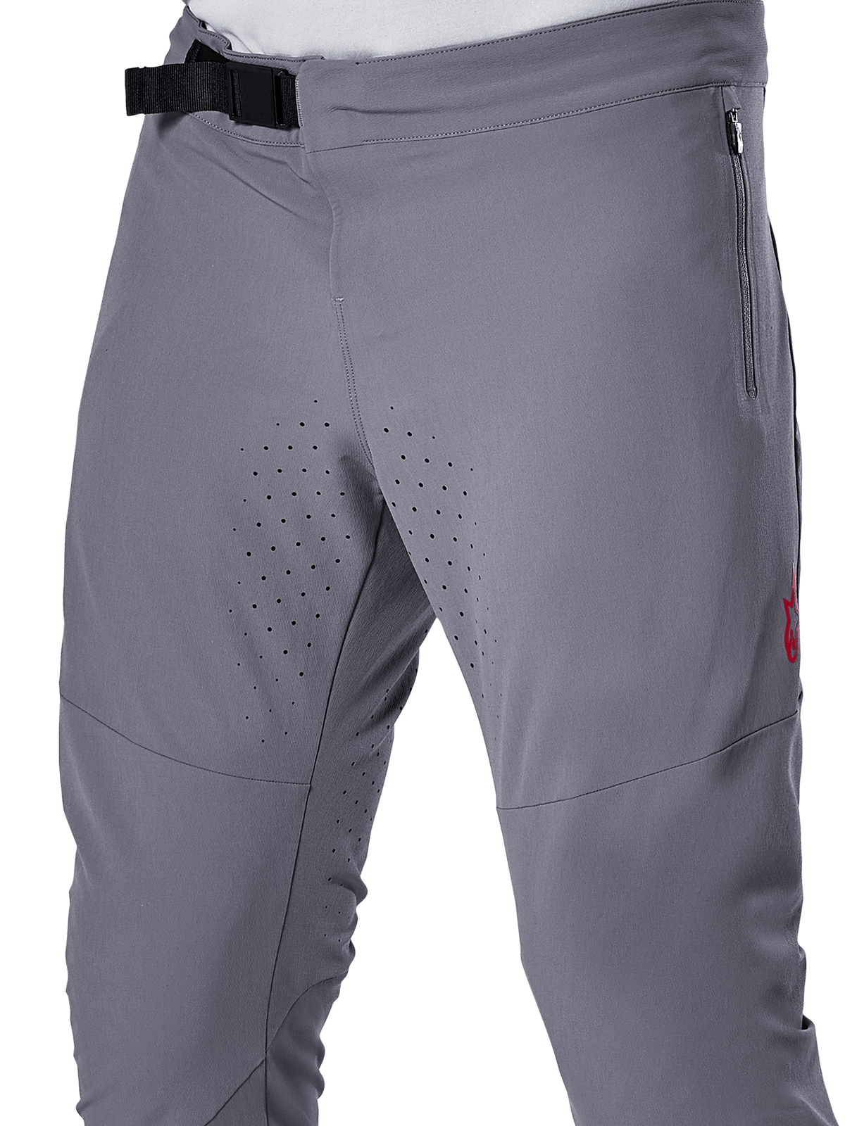 Alpinestars A-Aria Elite bukser, MTB-cykelbukser, mørkegrå, nærbillede med magnetisk spændelukning, lynlåslomme i siden og laserskårne ventilationsperforeringer på indersiden af lårene til trailkørsel.
