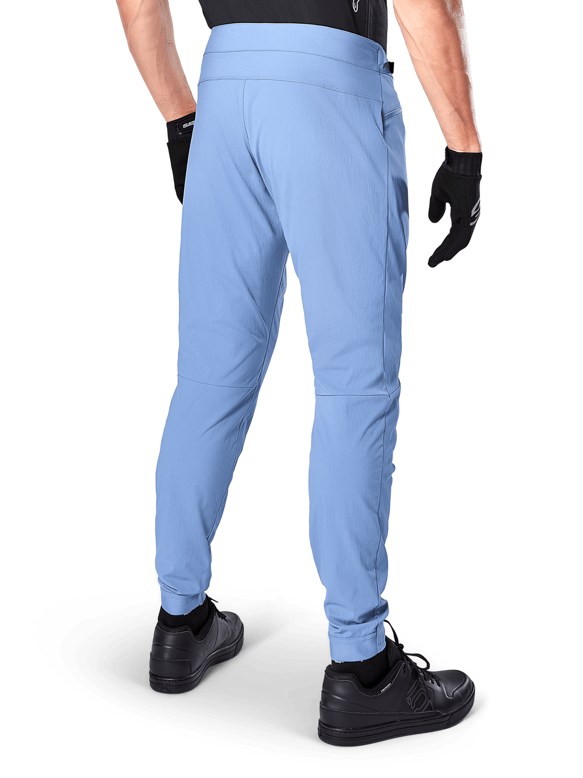 Alpinestars A-Dura Pants, Mountain Bike Pants, Infinity Blue, back view showing regular fit and elasticated cuffs, worn with black gloves and black footwear, durable 2-way stretch cycling apparel.