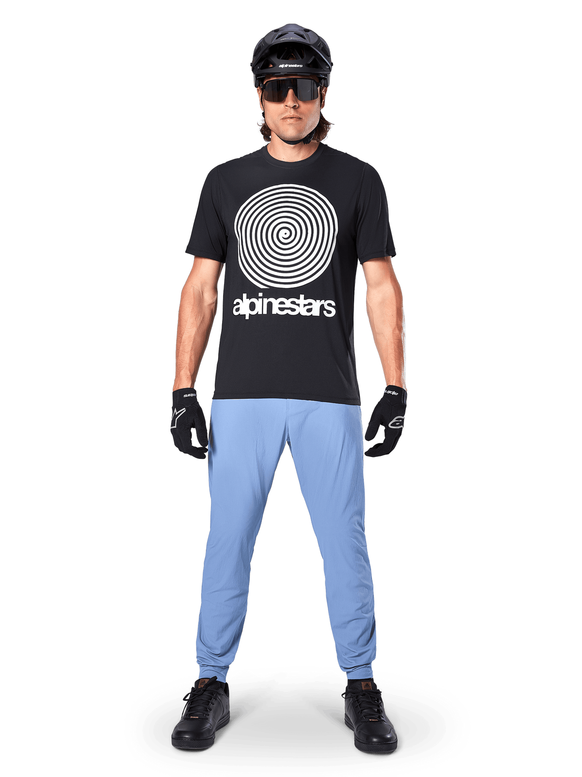 Alpinestars A-Dura Pants, Infinity Blue, MTB Pants worn with a black spiral graphic t-shirt, black gloves, and a black helmet, featuring a durable stretch fabric and elasticated cuffs, performance mountain bike gear