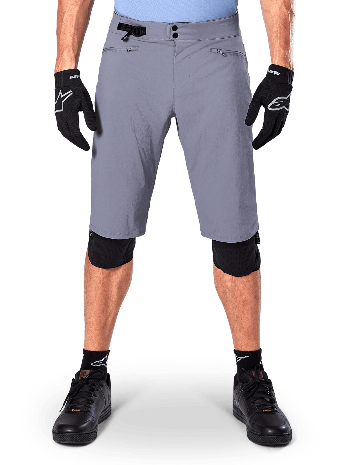 Alpinestars A-Dura Shorts, mountainbike-shorts, mørkegrå, båret med sorte Alpinestars handsker og knæbeskyttere, med dobbelt trykknaplukning og lynlåslommer med mesh-foring, slidstærkt 2-vejs strækstof til off-road cykling