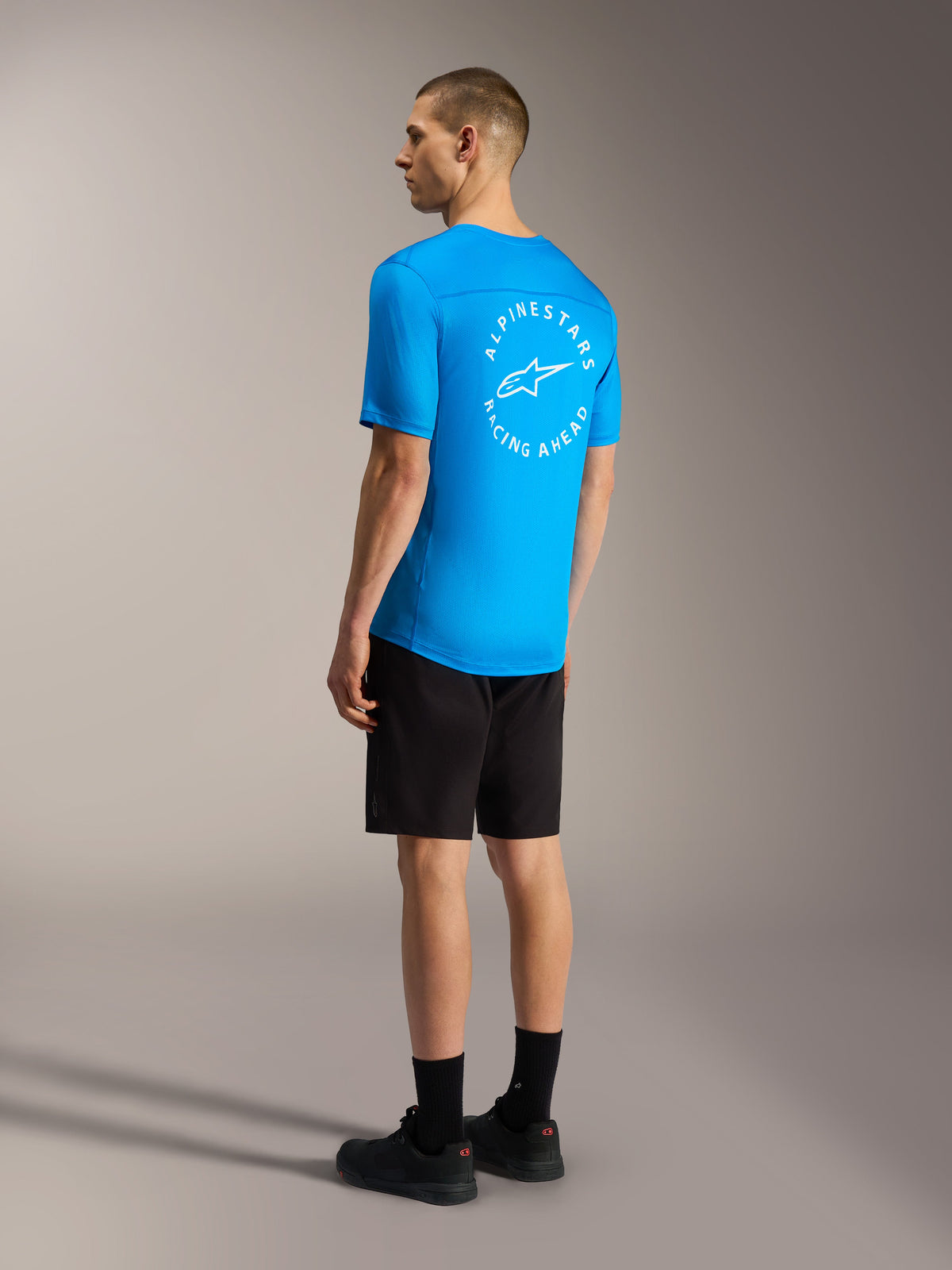 Lyseblå A-Dura Air SS jersey med hvidt cirkulært ryglogo og sorte A-Dura Ride shorts til mountainbike.