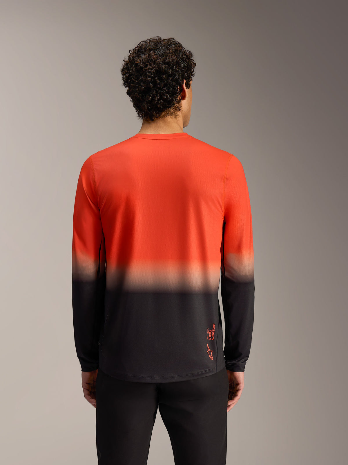 Alpinestars A-Dura ASTARS 2.0 Long Sleeve Jersey, orange and black gradient, back view of performance MTB trail gear.