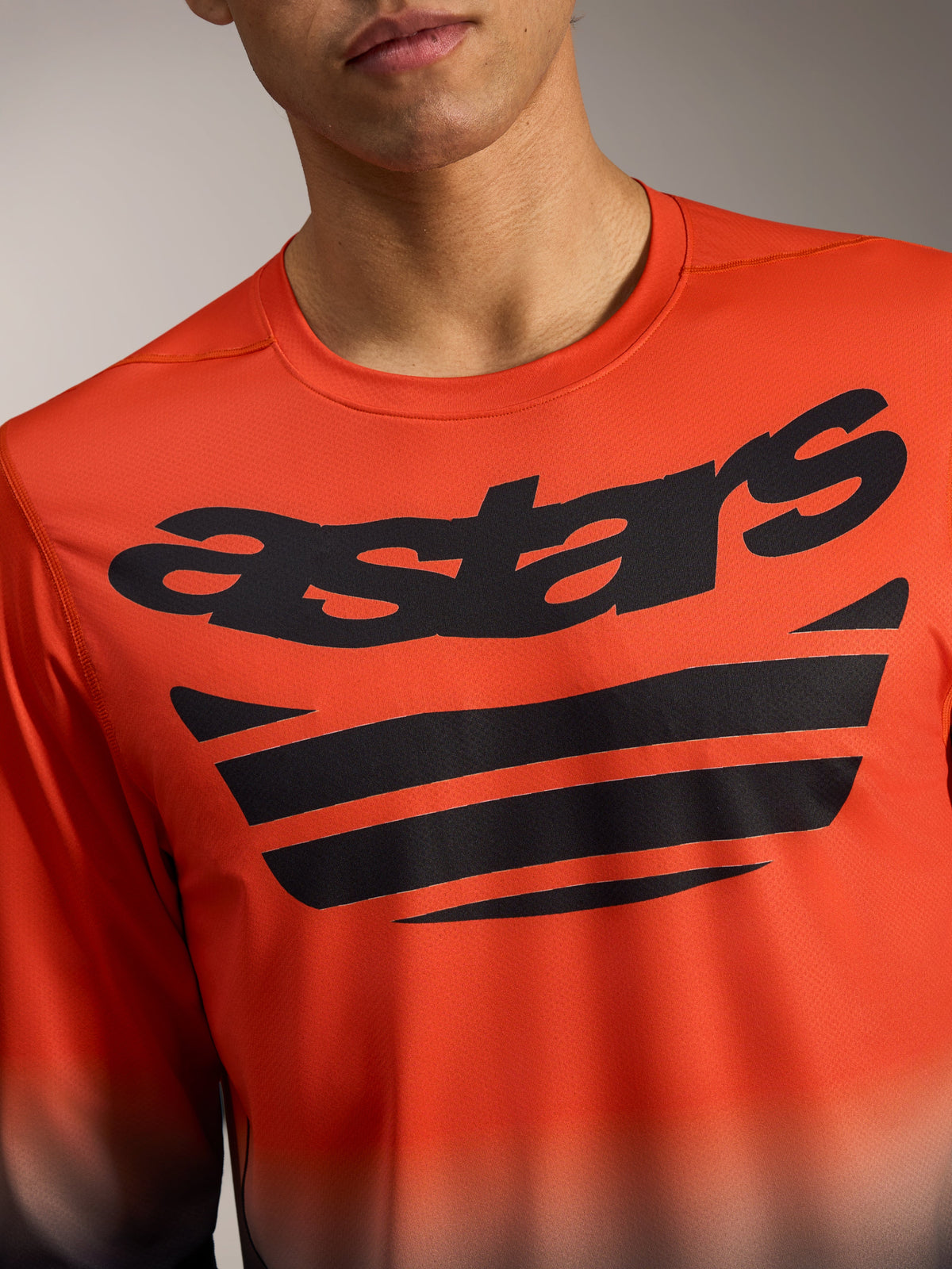 Orange and black A-Dura ASTARS Jersey 2.0 Long Sleeve with a bold chest wordmark and technical jacquard stretch fabric.
