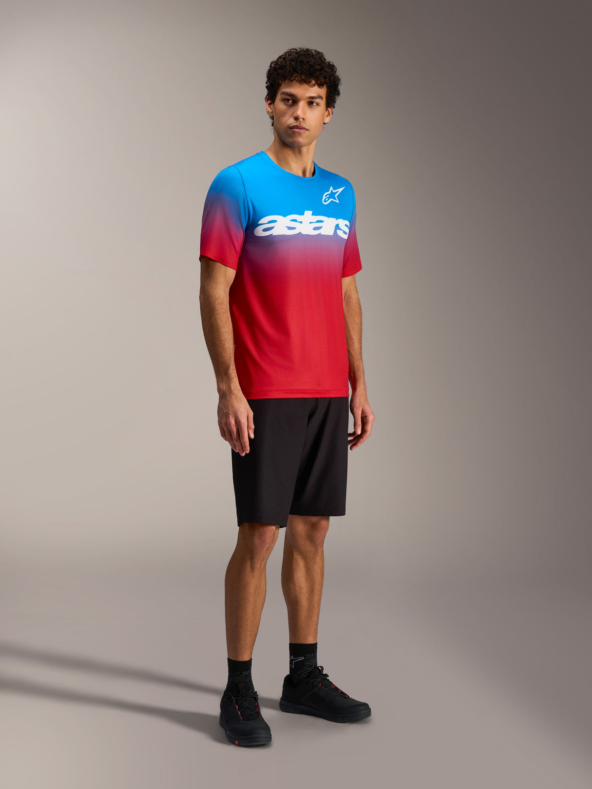 Alpinestars A-Dura ASTARS 2.0 MTB-jersey i klar rød og blå farveovergang, kortærmet top med hvidt logo på brystet.