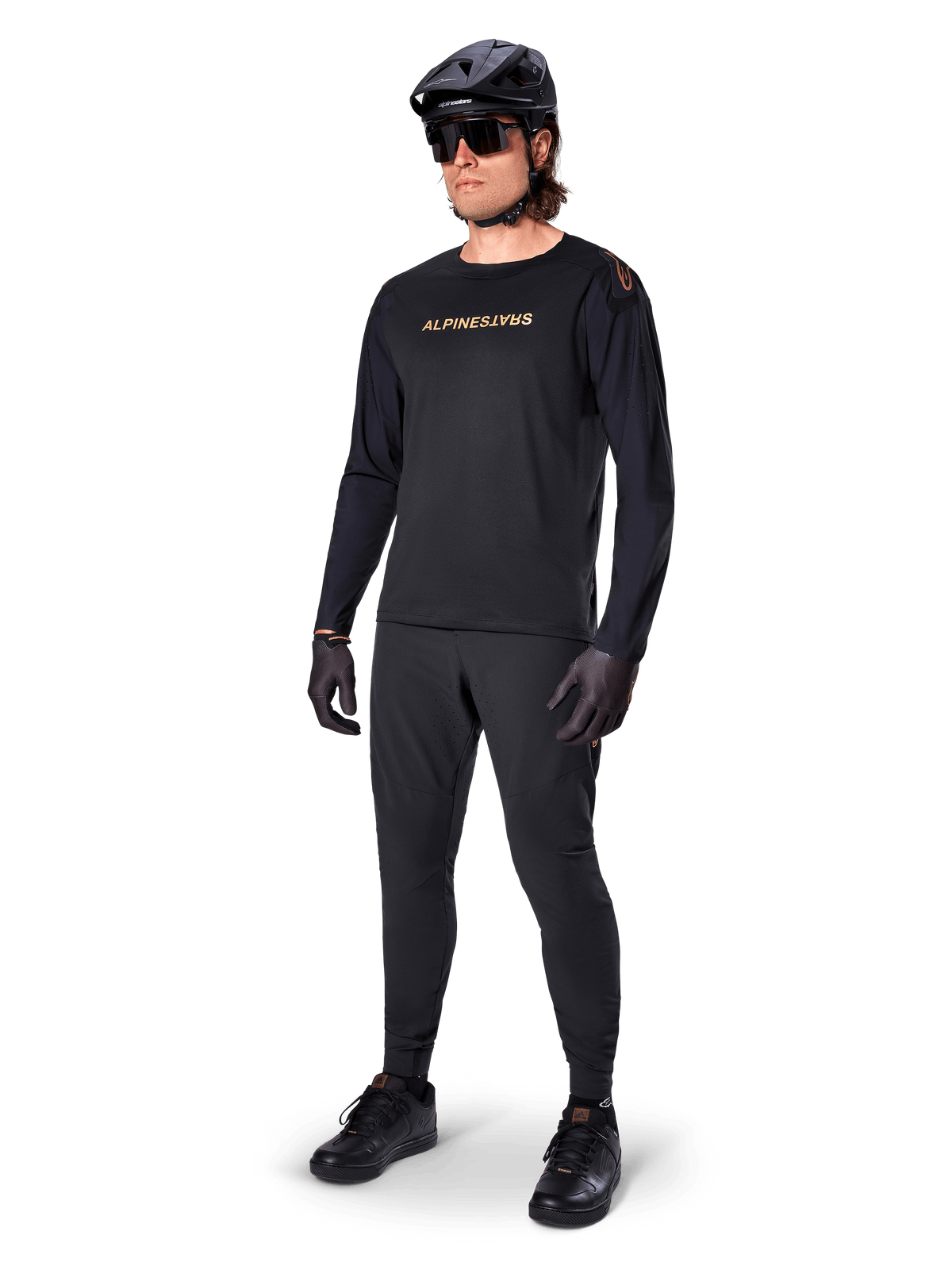 Alpinestars A-Aria Polartec Switch Long Sleeve Jersey, Black, bronze branding on chest, worn by mountain biker with black helmet and sunglasses, performance cycling apparel for trail riding