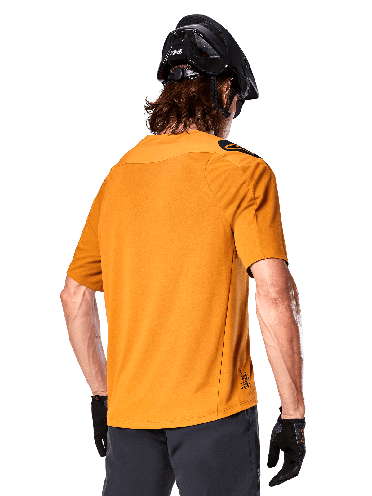 Alpinestars A-Aria Polartec Switch Jersey, Short Sleeve MTB Jersey, Dark Gold, back view showing performance fit, worn with black helmet and grey shorts, durable and breathable trail riding apparel