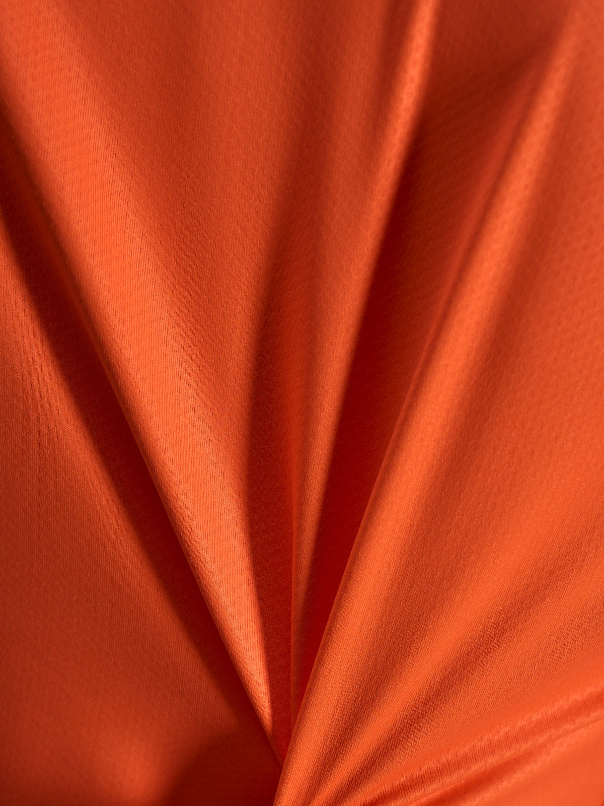 Orange jacquard-stofdetalje på Alpinestars Stella A-Dura Ride trøje, der viser den lette og strækbare tekstur.