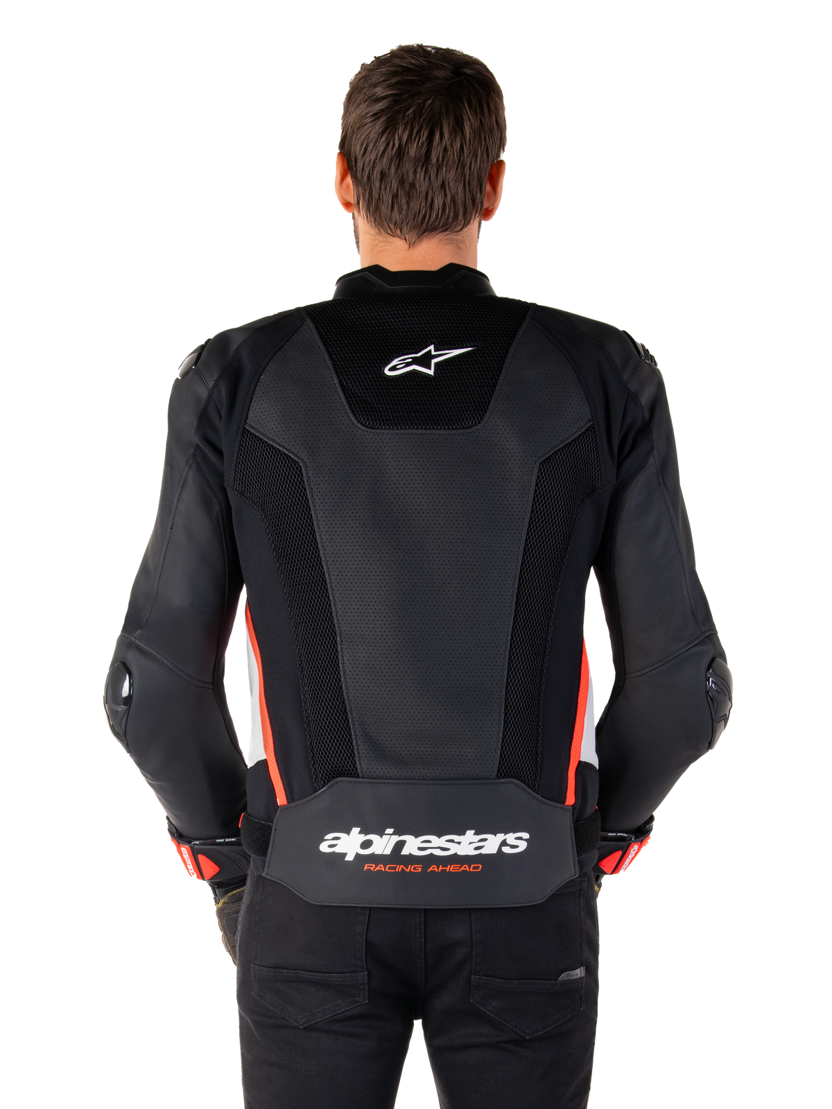 Set bagfra af en person iført Alpinestars Missile V3 Airflow læderjakke i Black White Red Fluo, med omfattende perforerede læderpaneler til ventilation, et lille Alpinestars-logo på den øverste del af ryggen og tydelig 'alpinestars RACING AHEAD'-branding nederst på taljen.