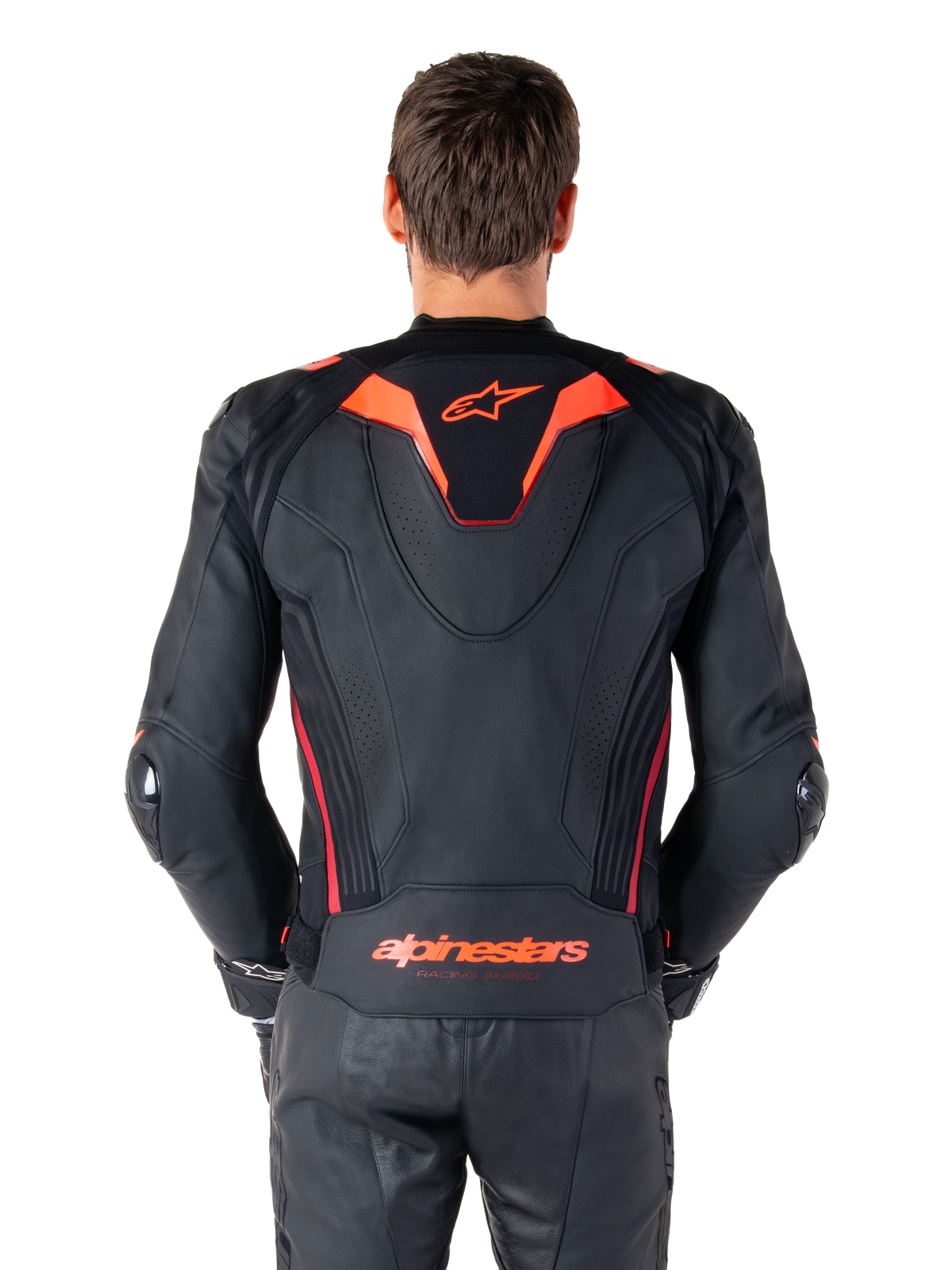 Alpinestars Missile V3 Ignition Leather Jacket, Rear View, Black with Red Fluo and Dark Red accents, featuring a sport aero-hump, Alpinestars branding on the back, worn with matching black leather riding pants, performance motorcycle racing gear