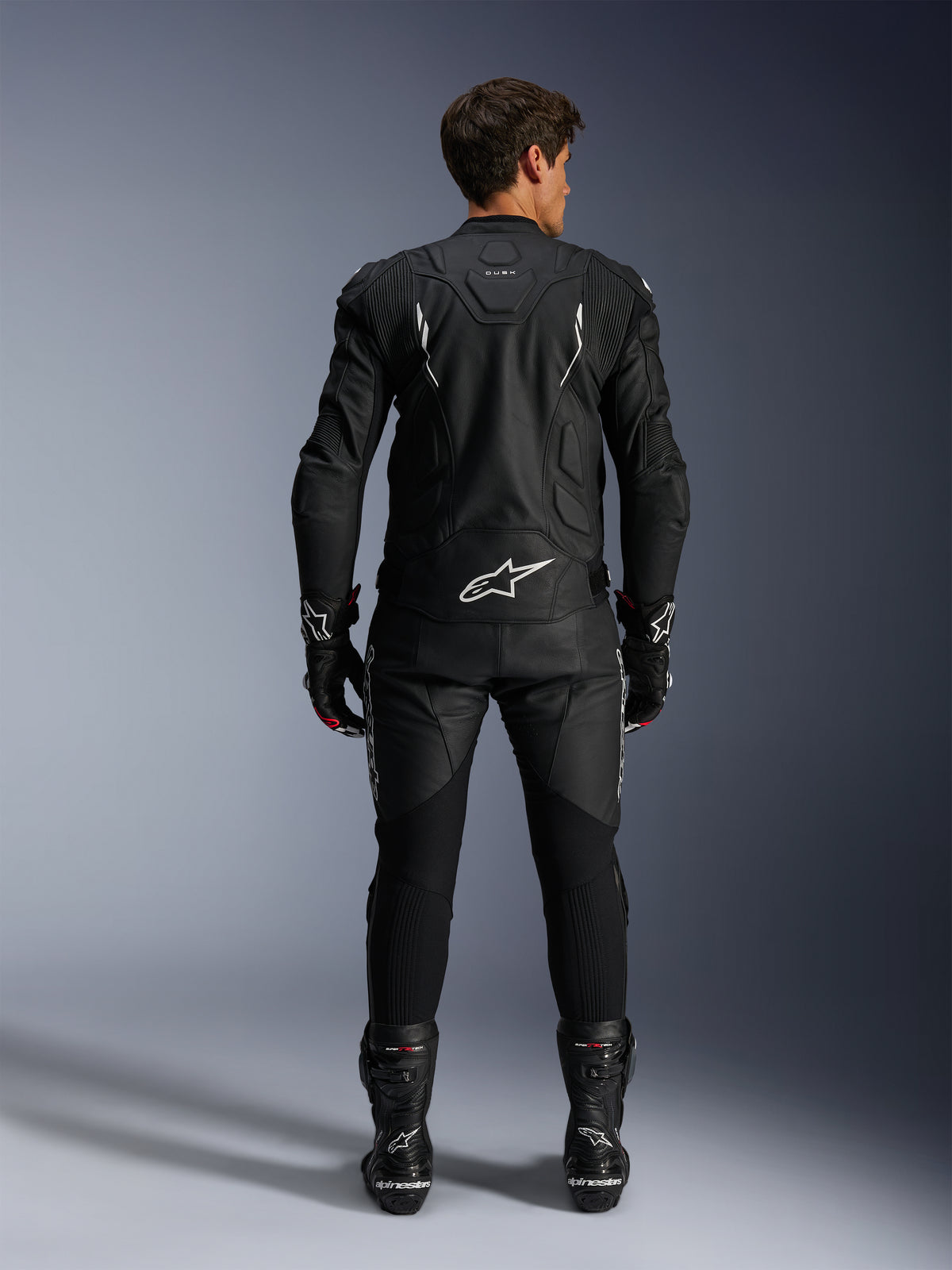 Alpinestars Dusk Leather Jacket AND Missile V3 Leather Pants, men's black and white leather racing suit, rear view.