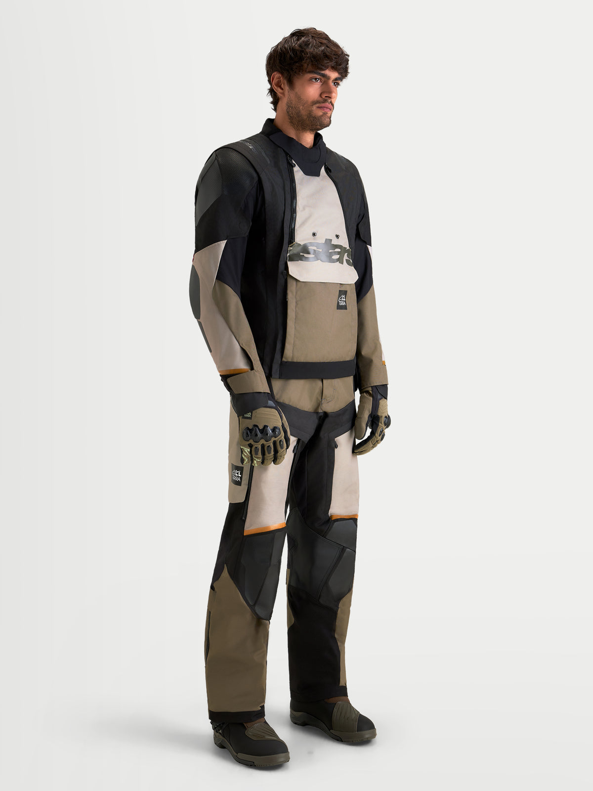 Alpinestars Harok V2 Drystar Gear Set, adventure touring motorcycle jacket and pants in black, khaki, and camouflage, three-quarter view worn by a male model with matching gloves and boots, all-weather waterproof riding apparel