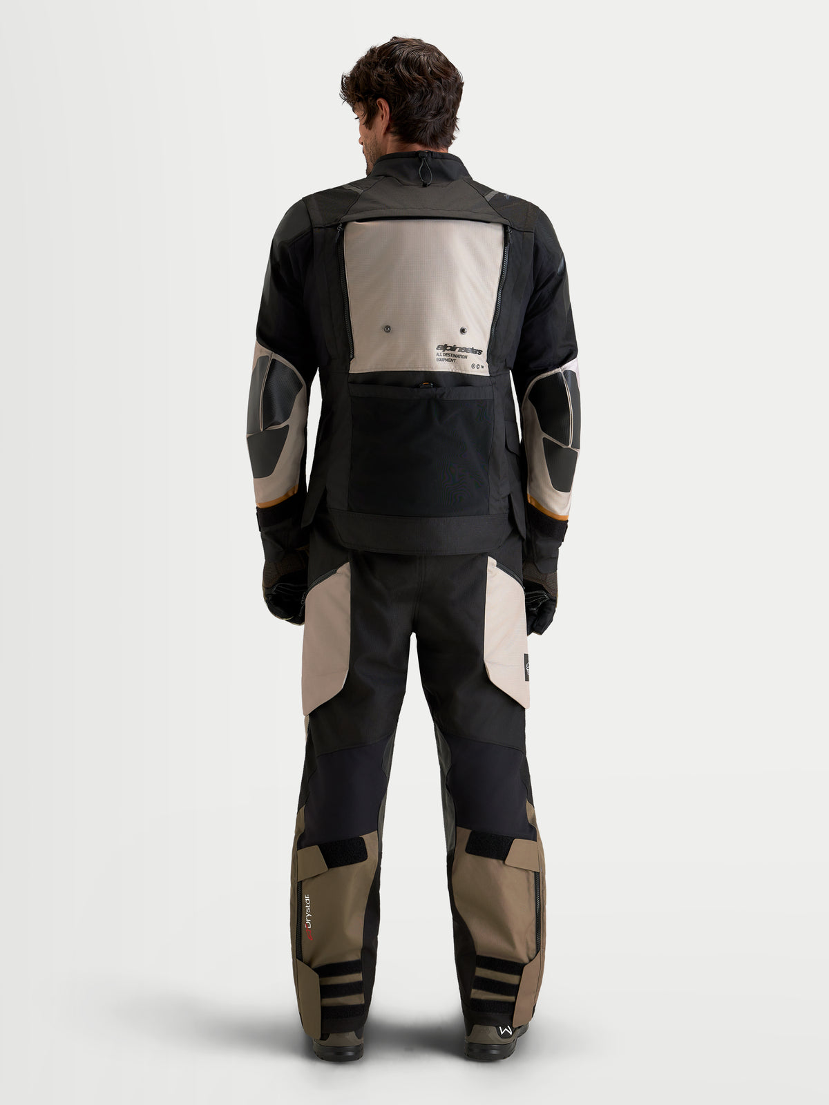 Alpinestars Harok V2 Drystar® Gear Set, men's adventure touring motorcycle jacket and pants in black and khaki, rear view on a model wearing waterproof textile riding apparel with reinforced protection details