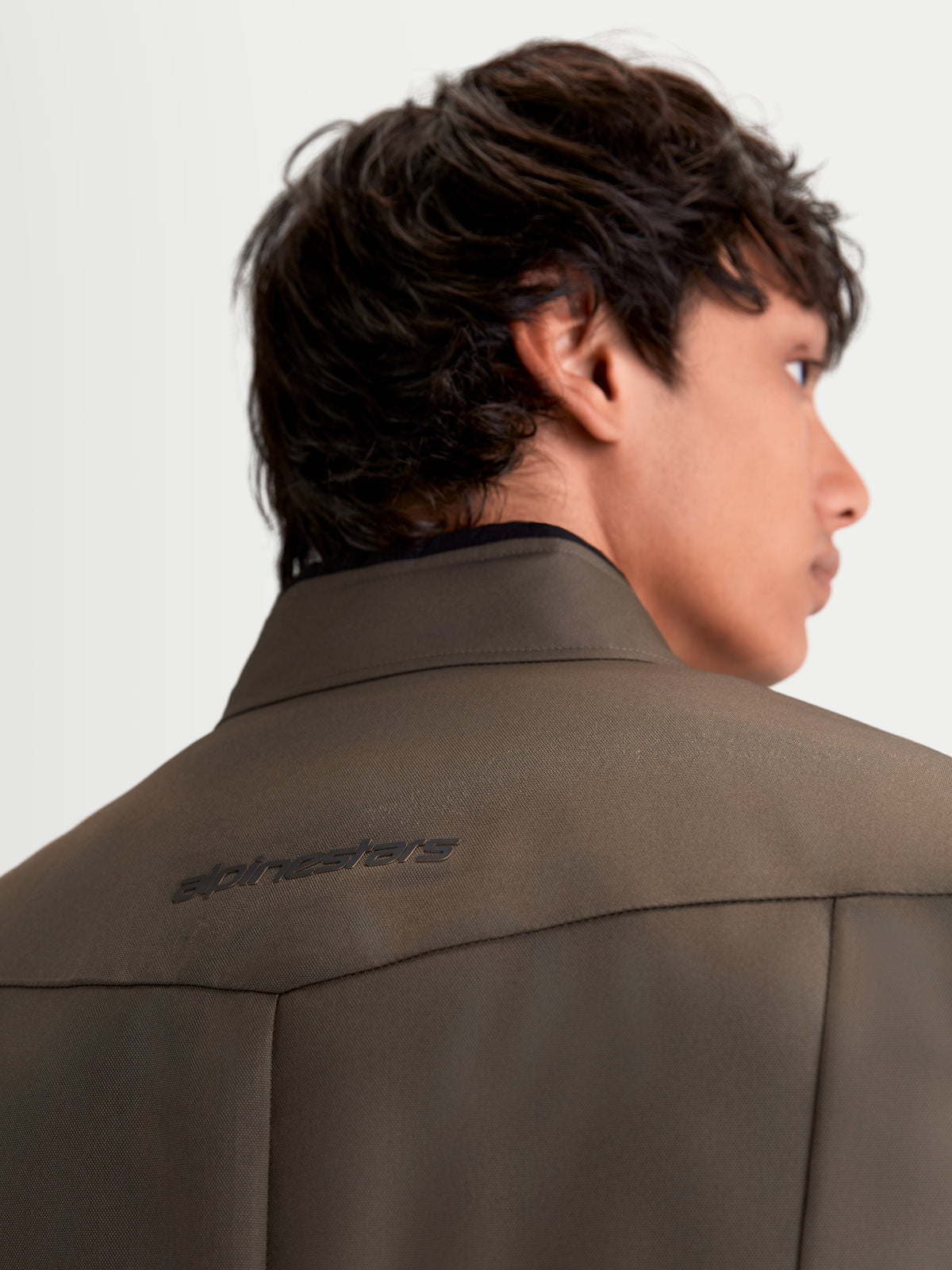 Alpinestars C-1 Waterproof Jacket, men's urban contemporary motorcycle textile jacket in walnut black, rear close-up view showing 3D back pattern and soft-finish collar worn by a model