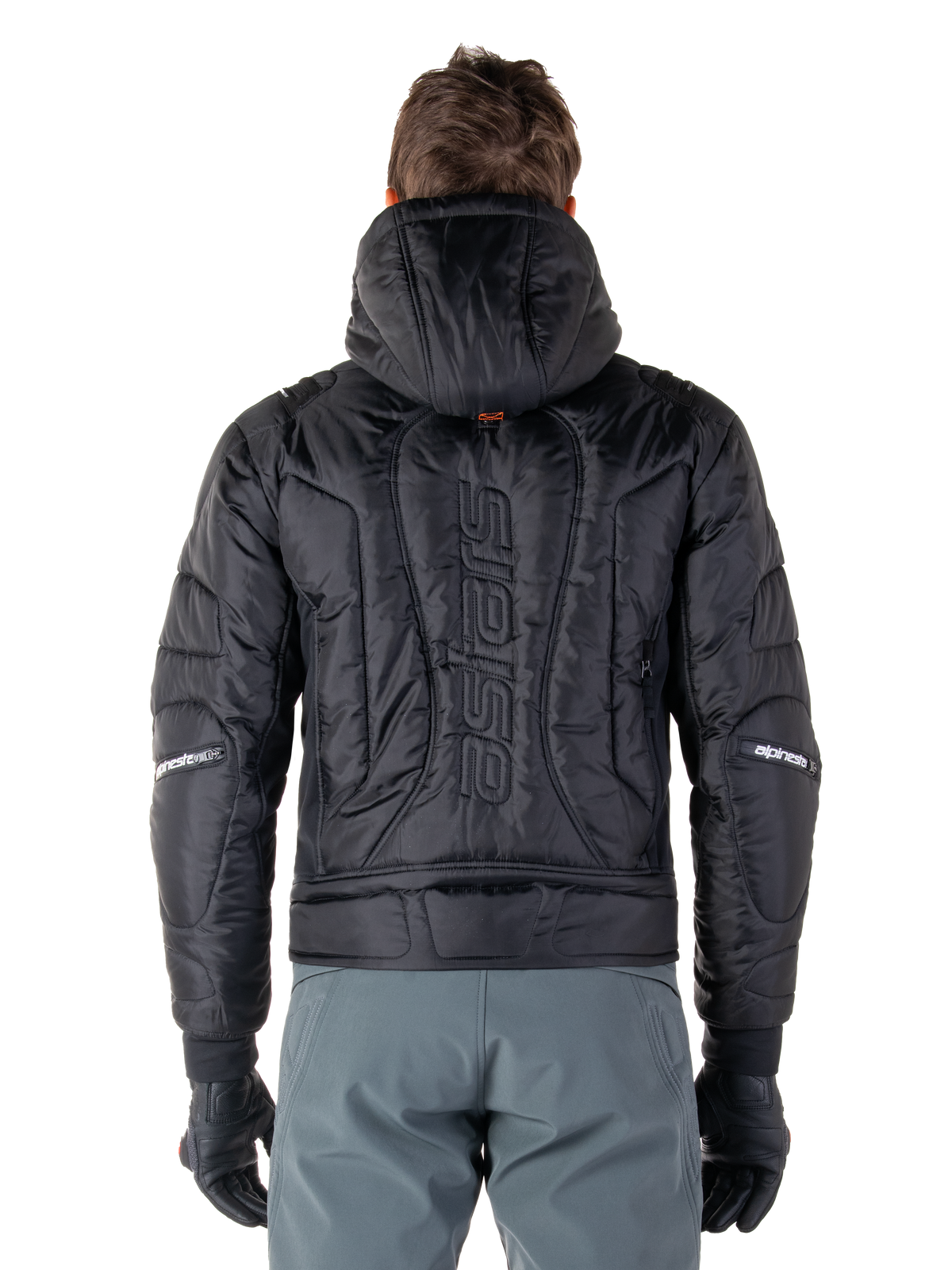 Alpinestars Mohobbs Vandtæt Jakke, sort, set bagfra viser quiltet polstret konstruktion, lodret 'astars'-ordmærke på ryggen, hætten oppe, moderne moto-streetwear-stil
