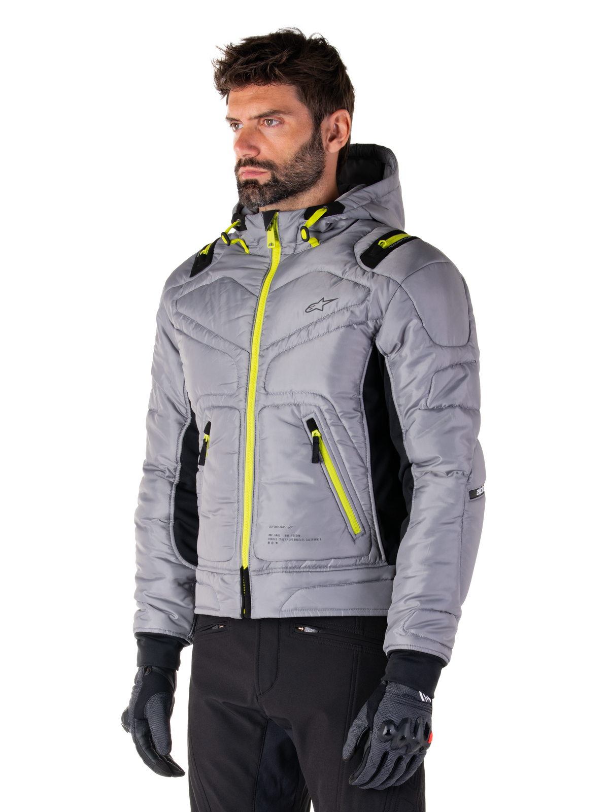Alpinestars Mohobbs Waterproof Jacket, Lunar Gray Lime Punch, vatteret bomber-motorcykeljakke til mænd med neongule lynlåse og snoretræksdetaljer, båret med sorte kørebukser og handsker, moderne urban moto-streetwear-design med hætte