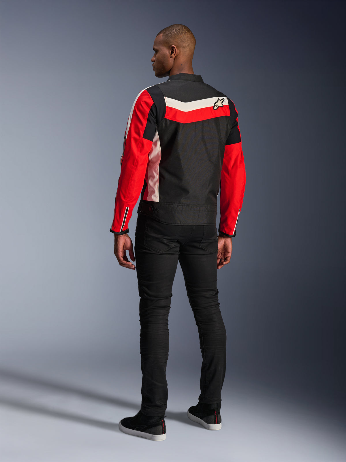 Alpinestars T-Dyno WR-jakke, tekstil motorcykeljakke, sort, klar rød og ecru, set bagfra på model, vintage-inspireret biker-pasform med klassiske farvepaneler og logo, moderne urbant vej-udstyr.