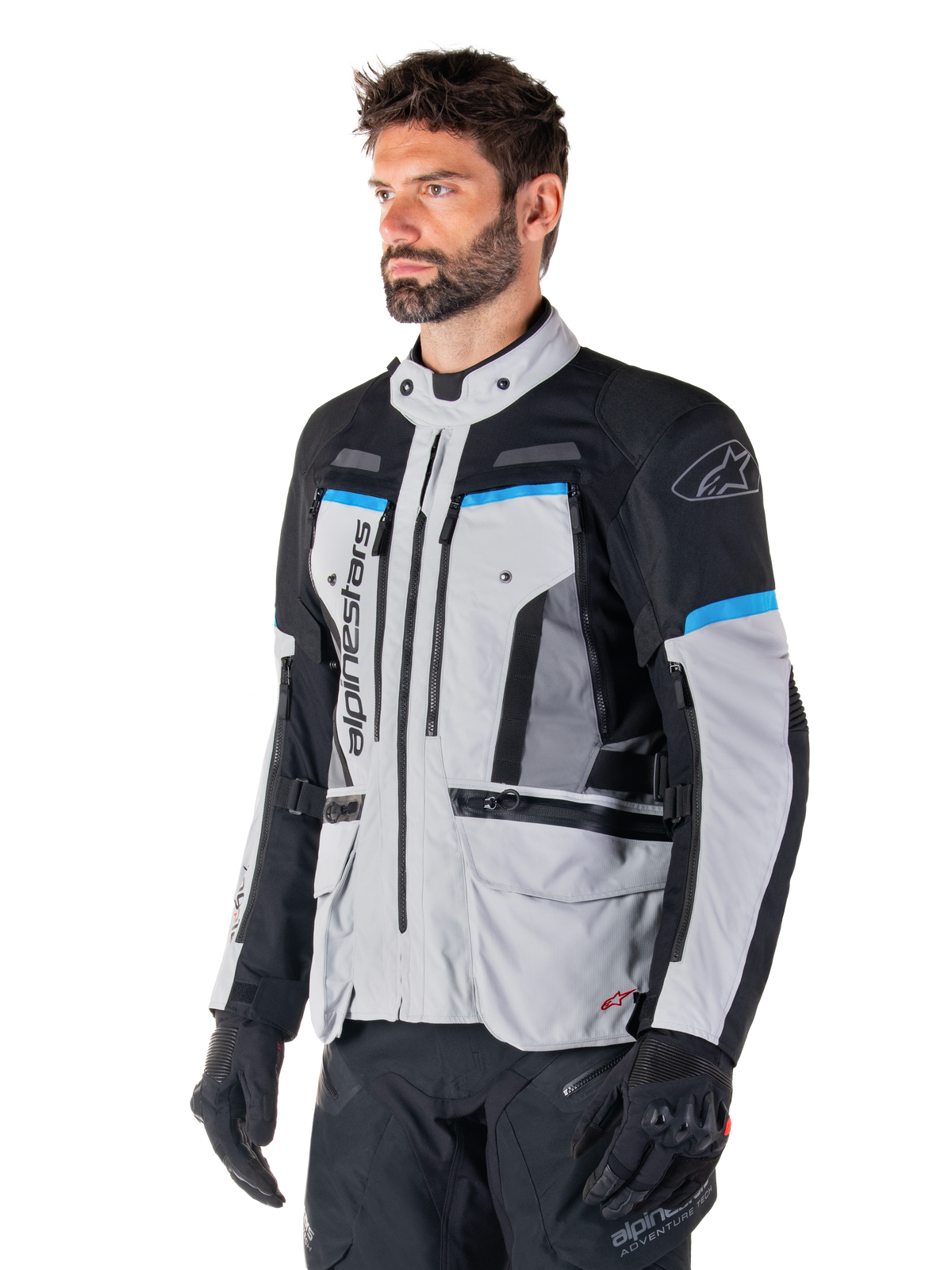 Alpinestars Bogota' Pro Drystar® herre-motorcykeljakke i isgrå og sort med cyan detaljer, teknisk adventure-tekstil.