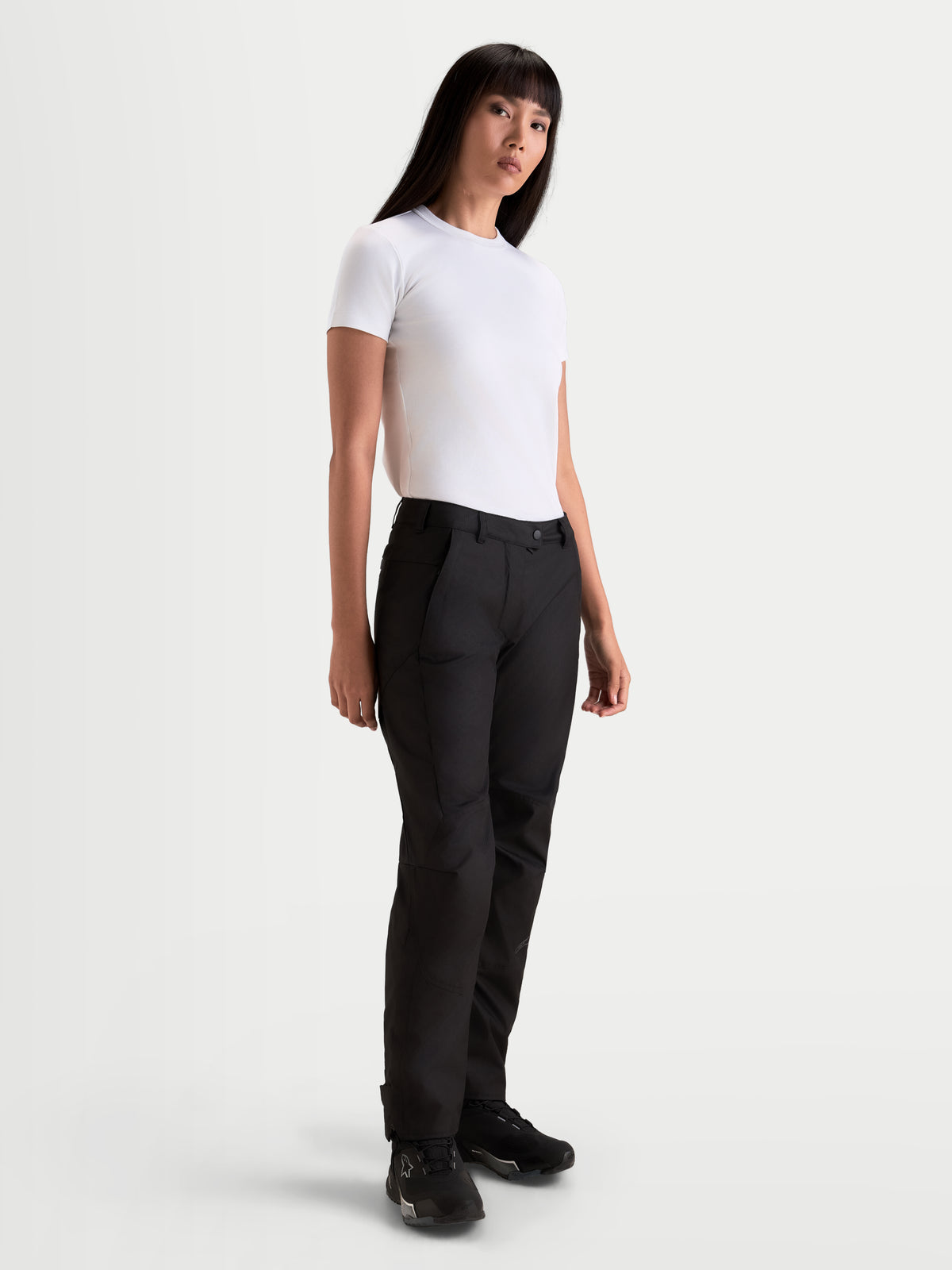 Alpinestars Stella C-1 Waterproof bukser, sorte dame-motorcykelbukser i lige snit, båret af model med hvid t-shirt til koldere køredage