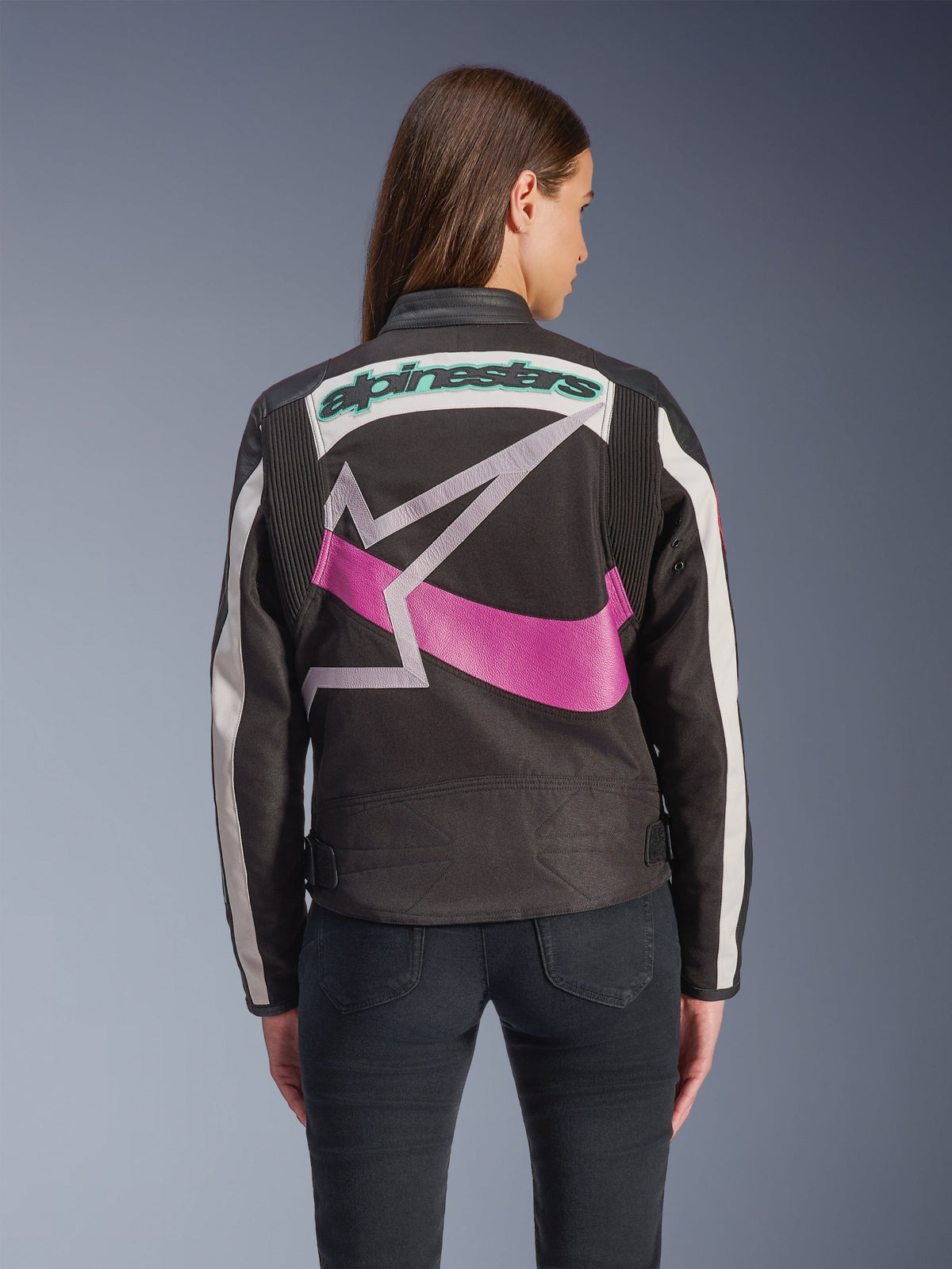 Alpinestars Idles Women’s Jacket, Rear View, Black Off White and Purple, large graphic star logo on the back, teal embroidered wordmark, accordion panels on shoulders, vintage-inspired urban motorcycle gear
