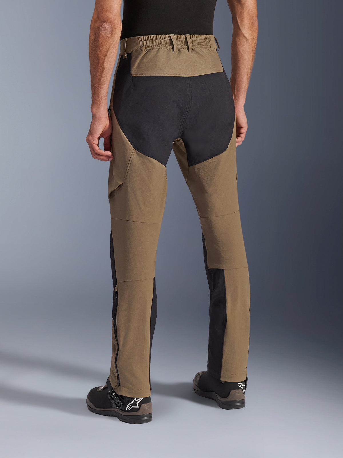 Alpinestars Flex-AST Explorer Pants, Walnut Black adventure motorcycle pants, rear view showing black ripstop panels on the seat and legs, elasticated waistband and durable stretch textile construction.
