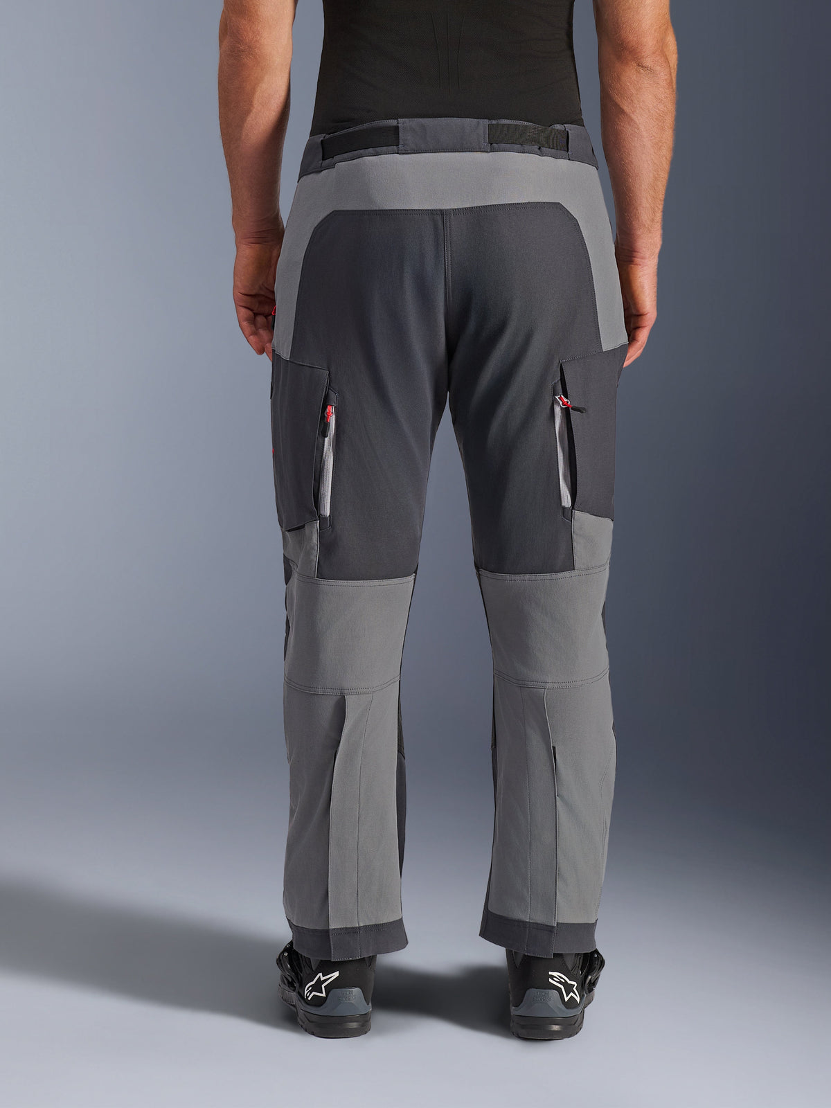 Alpinestars Maxdura Dual Pants, Adventure Motorcycle Pants, Dark Gray and Deep Gray, back view highlighting reinforced seat and knee panels, zippered thigh vents, worn with black Alpinestars boots, rugged stretch polyamide construction for dual-sport riding.