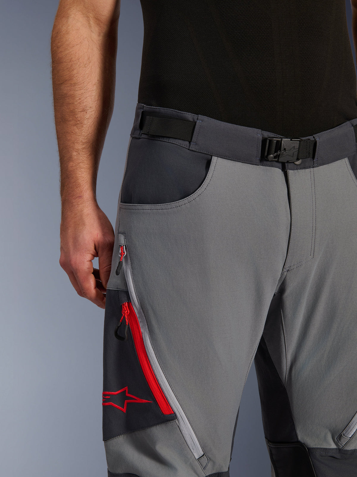Alpinestars Maxdura Dual Pants, Adventure Motorcycle Pants, Dark Gray and Deep Gray, close-up featuring adjustable waist belt with magnetic buckle, zippered cargo pocket with red detailing and Alpinestars logo.