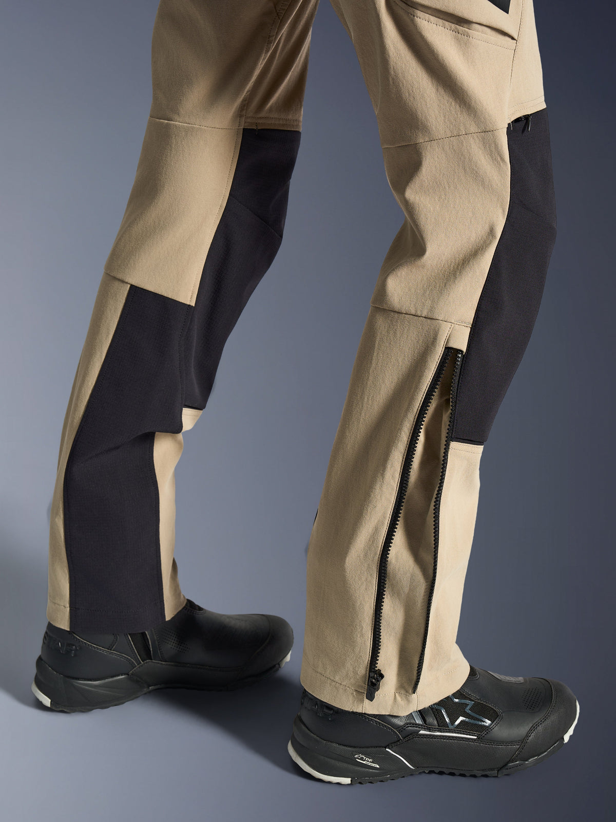 Alpinestars Stella Flex-AST Explorer Pants, Women's Motorcycle Pants, Sand and Black, close-up of the lower legs showing a zippered hem for boot fit, worn with black Alpinestars riding shoes, featuring durable ripstop and breathable stretch fabric panels.