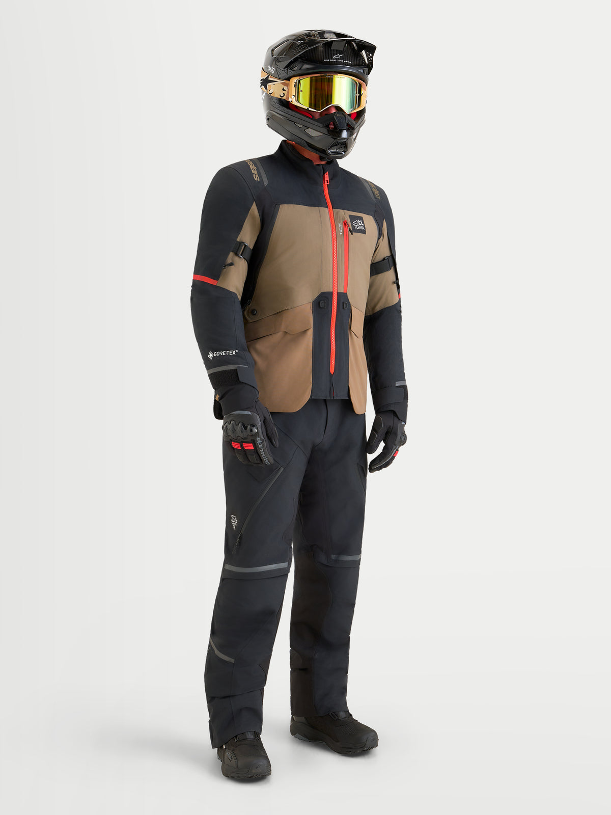Alpinestars St-7 V2 2L Gore-Tex Gear Set, adventure touring motorcycle jacket and pants in black, khaki brown, and red, worn by a model with helmet and matching gear, waterproof textile construction