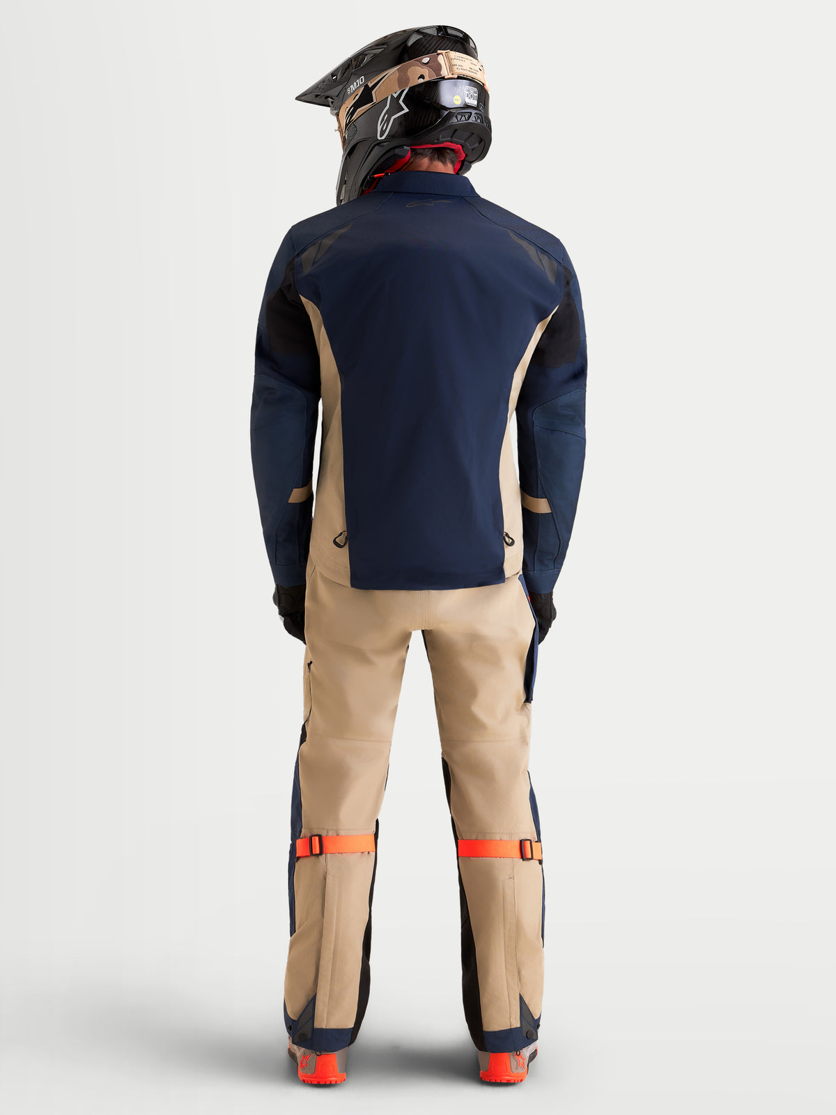Alpinestars Arenis Gore-Tex Gear Set, men's adventure touring motorcycle jacket and pants in night navy and aluminum, rear profile view on a model wearing matching gear and helmet, waterproof all-terrain riding apparel