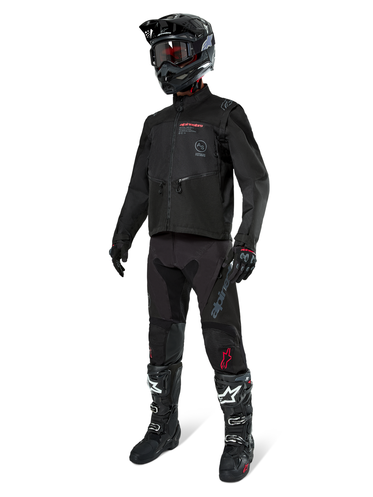 Motocross-kører i komplet racerudstyr, Alpinestars Pro-Dura-jakke i sort, sorte bukser med grå branding og røde detaljer, sort hjelm med goggles og sort-hvide motocross-støvler, koordineret outfit til enduro- og off-road-kørsel