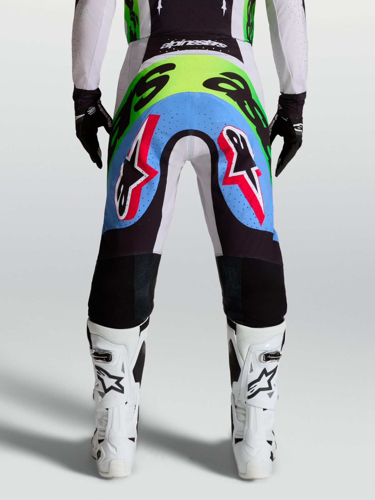 Alpinestars Supertech Dyna Men's Motocross Pants, rear view in light lilac and green fluo with perforated stretch panels.