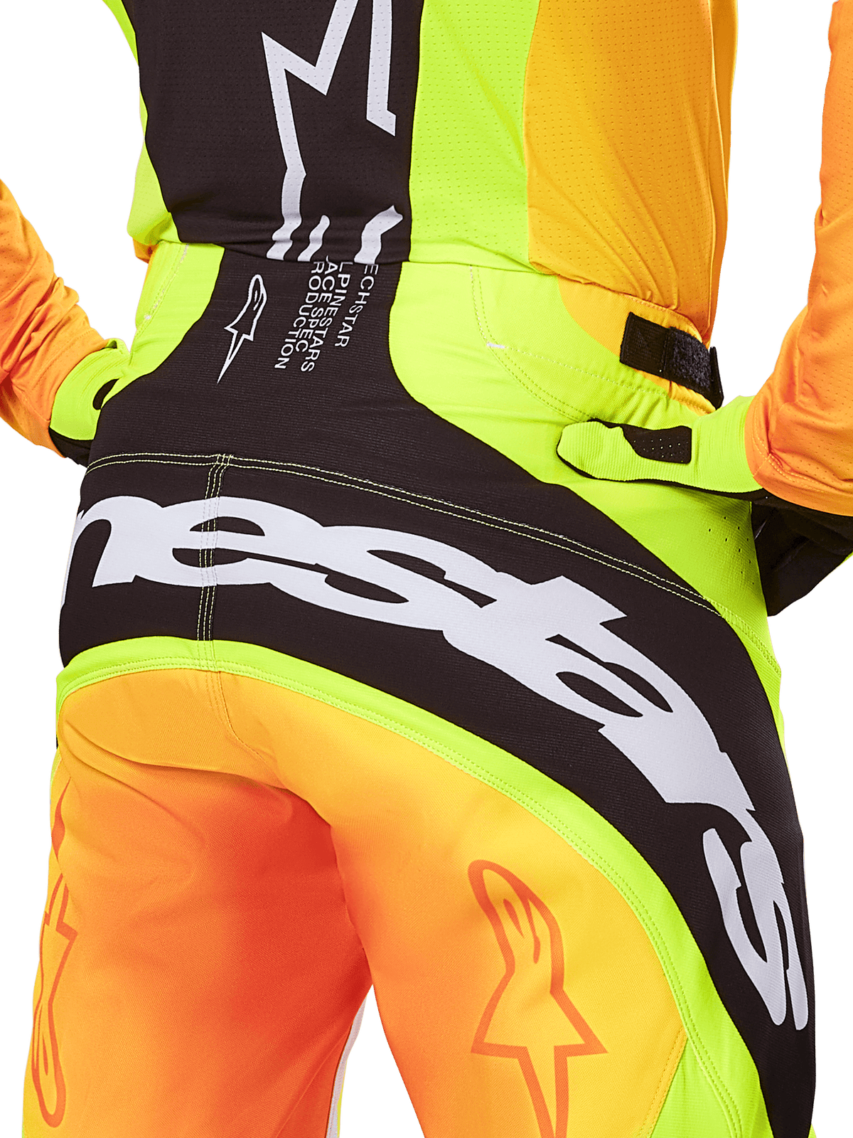 Alpinestars 2025 Techstar Melt bukser, motocrossbukser, nærbillede bagfra, neongul og orange med sorte paneler, stort hvidt Alpinestars-branding over sædet, high-performance udstyr til terrænkørsel