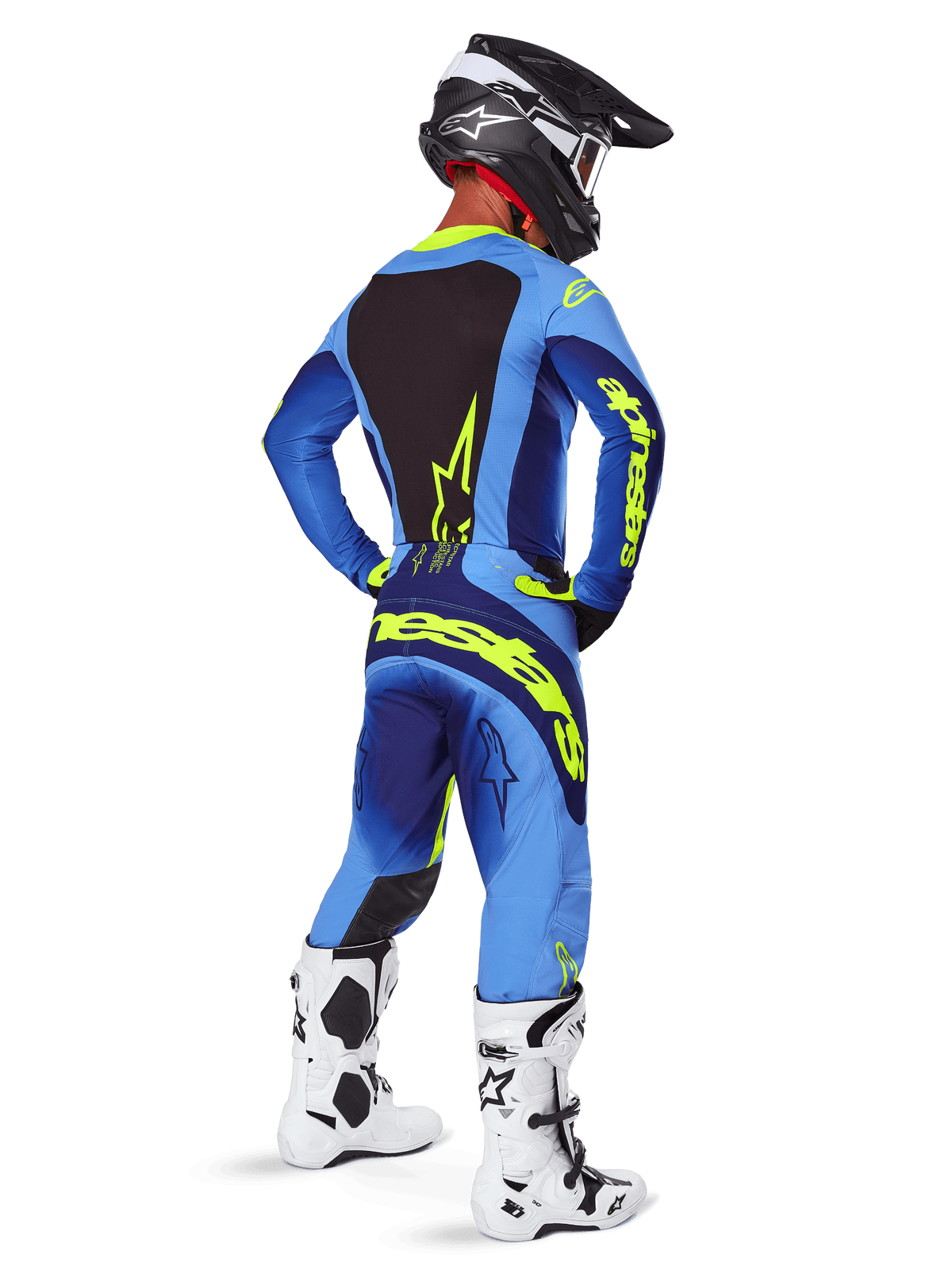 Alpinestars 2025 Techstar Melt bukser, motocross-udstyr, gul fluo blå, set bagfra af kører iført matchende blå trøje med stort gult logo, hvide og sorte støvler og sort hjelm, koordineret racersæt til terrænkørsel