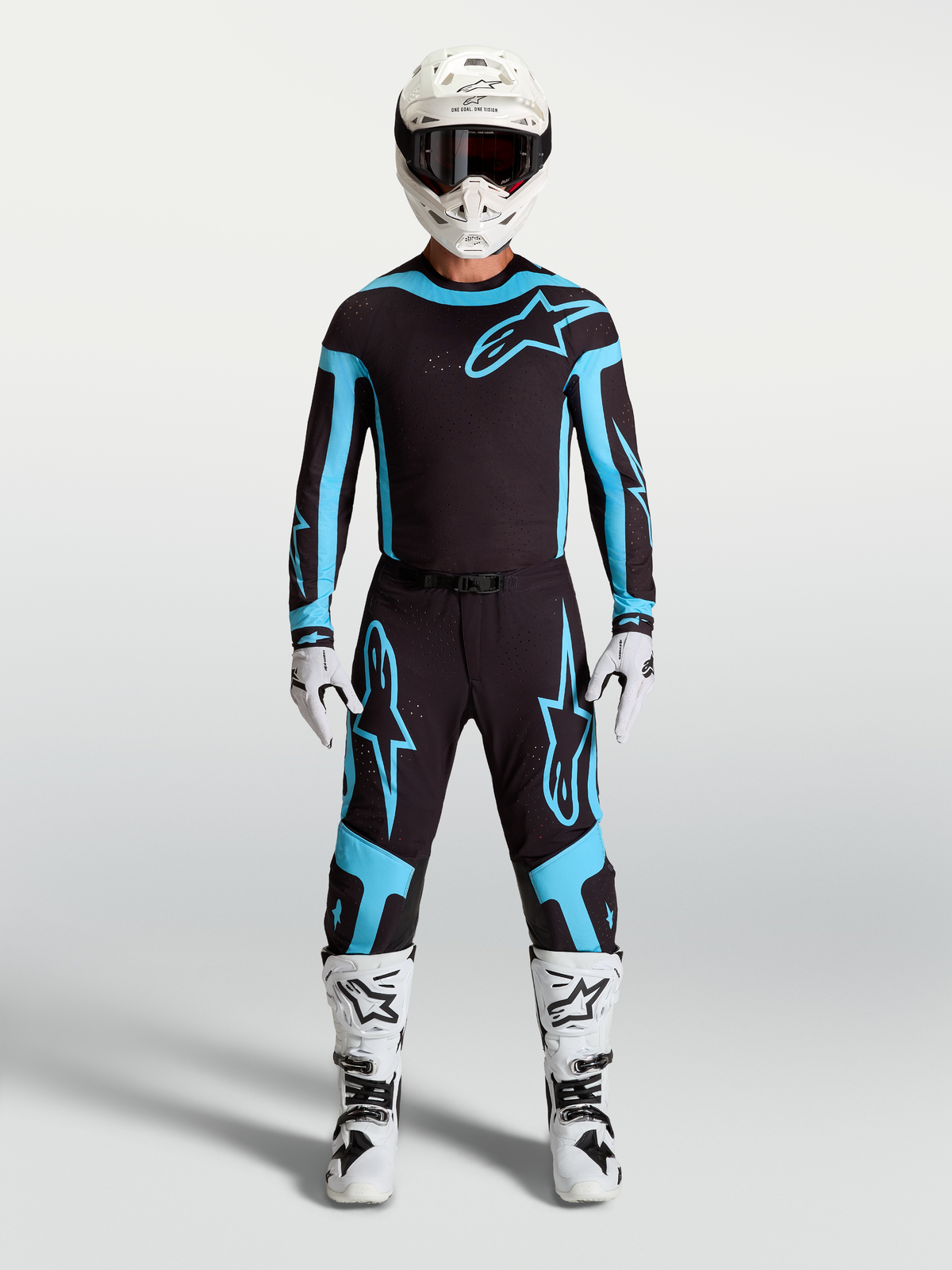 Alpinestars Supertech Vesta Pants, men's motocross racing gear in black and turquoise, featuring lightweight stretch construction on model.