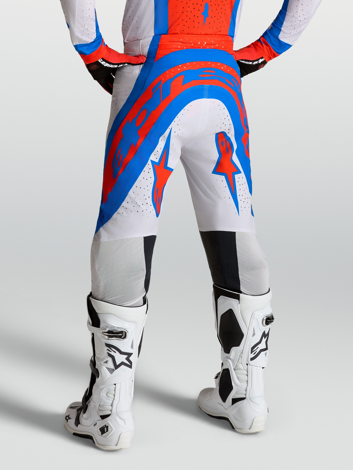 Alpinestars Supertech Vesta Pants, pro-level motocross pants in white, red, and blue with perforated stretch rip-stop fabric.