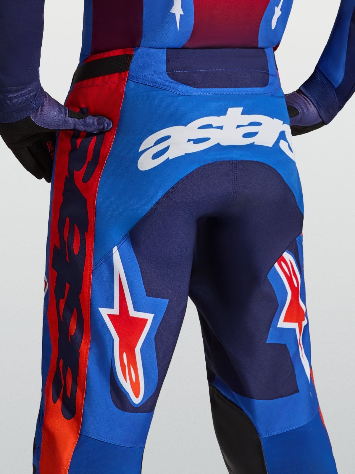 Alpinestars Racer Hunt Bukser, herre-motocrossbukser i blå og rød med hvid astars-branding og stjernegrafik bagpå.