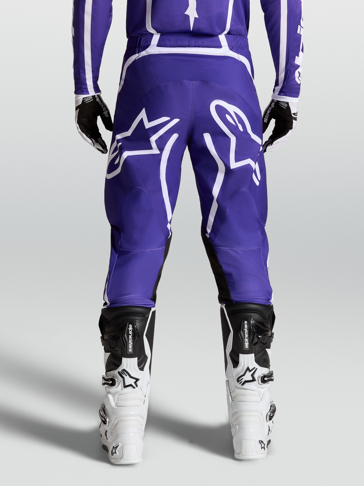 Alpinestars Fluid Apex V2 Pants, Men's Motocross and Off-Road Riding Pants, Deep Blue and White, durable 600D polyfabric and pre-curved leg design shown from the rear on model with boots.