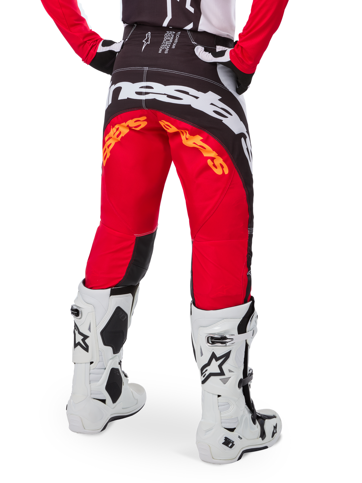 Alpinestars Limited Edition Techstar Deep Pants, Motocross Pants, Black White and High Red, rear view featuring bold white Alpinestars logo across the seat and orange branding, worn with white technical boots for professional off-road racing.