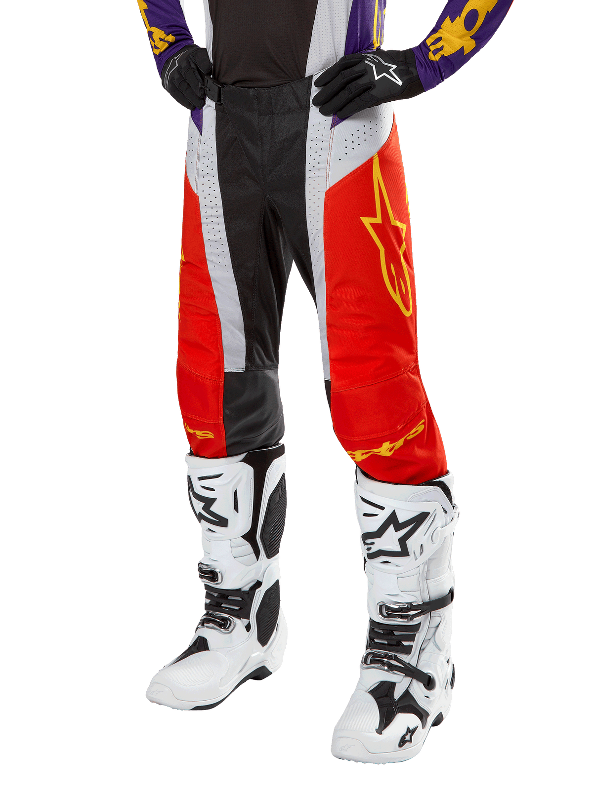 Alpinestars 2024 Techstar Ocuri bukser, motocross racerbukser, Hot Orange, sort og hvid med gul stjernegrafik, båret med lilla jersey og hvide støvler, slidstærkt præstationsudstyr til off-road konkurrence