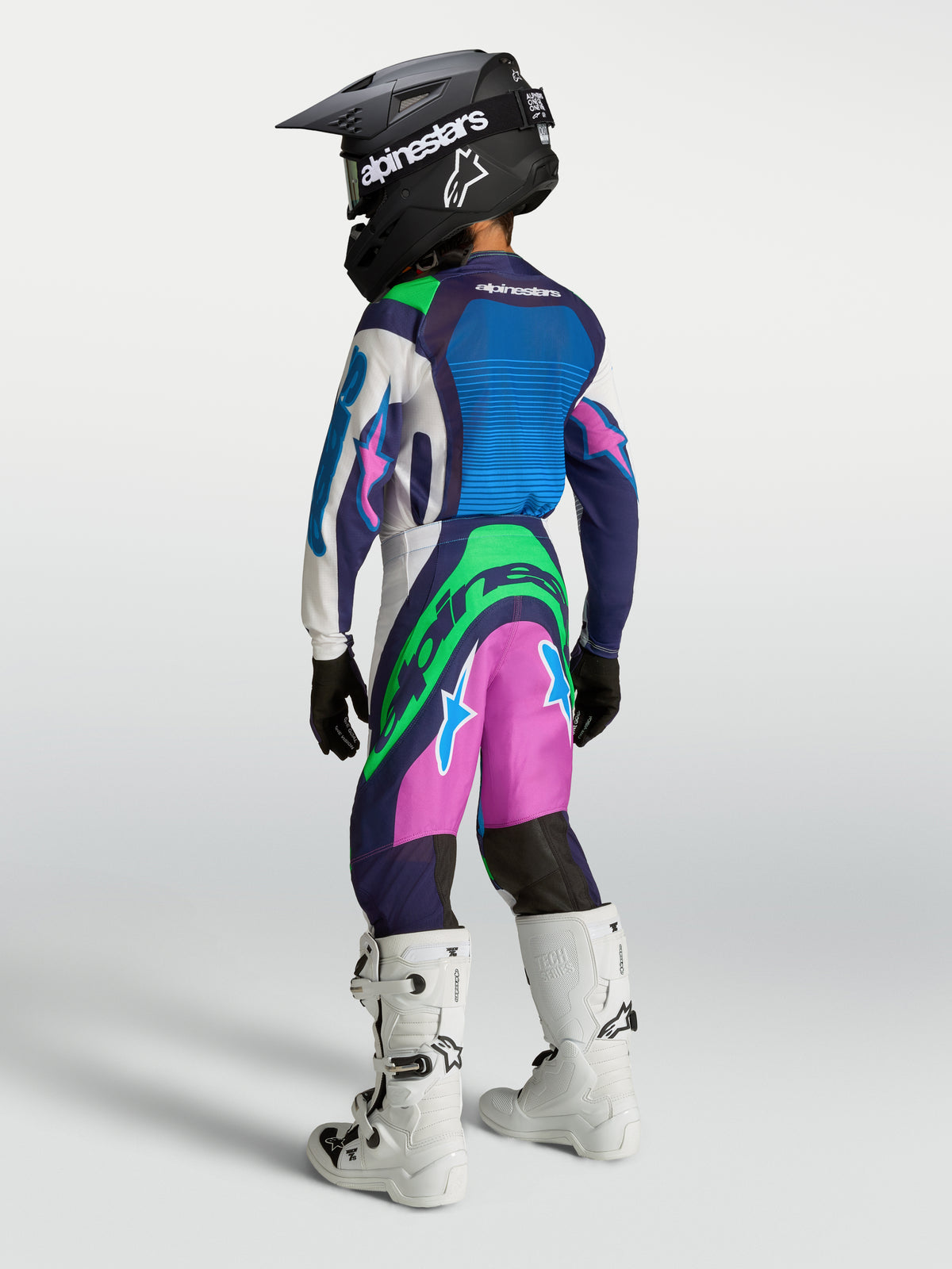 Alpinestars Bukser Supertech Maven Ungdom, motocrossudstyr i blå, pink og grøn, performance-pasform til unge racerentusiaster.