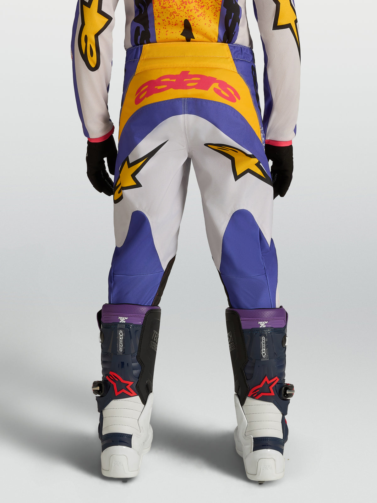 Alpinestars Youth Fluid Drag Pants, youth motocross gear in blue and gold, featuring a durable 600D construction and star graphics.