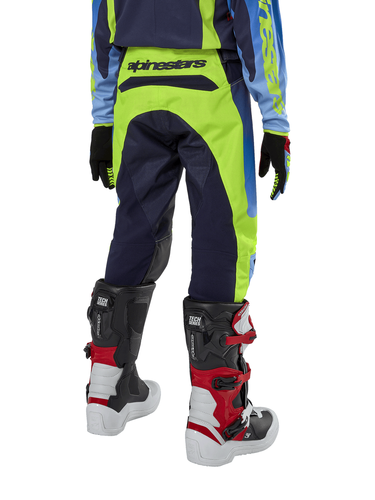 Alpinestars Youth 2024 Racer Hoen Pants, Motocross Pants, Yellow Fluo and Blue Night Navy, rear view showing bold Alpinestars branding on the waistband, worn with black and red Tech Series boots and coordinating jersey, durable sport fit for youth off-road riding